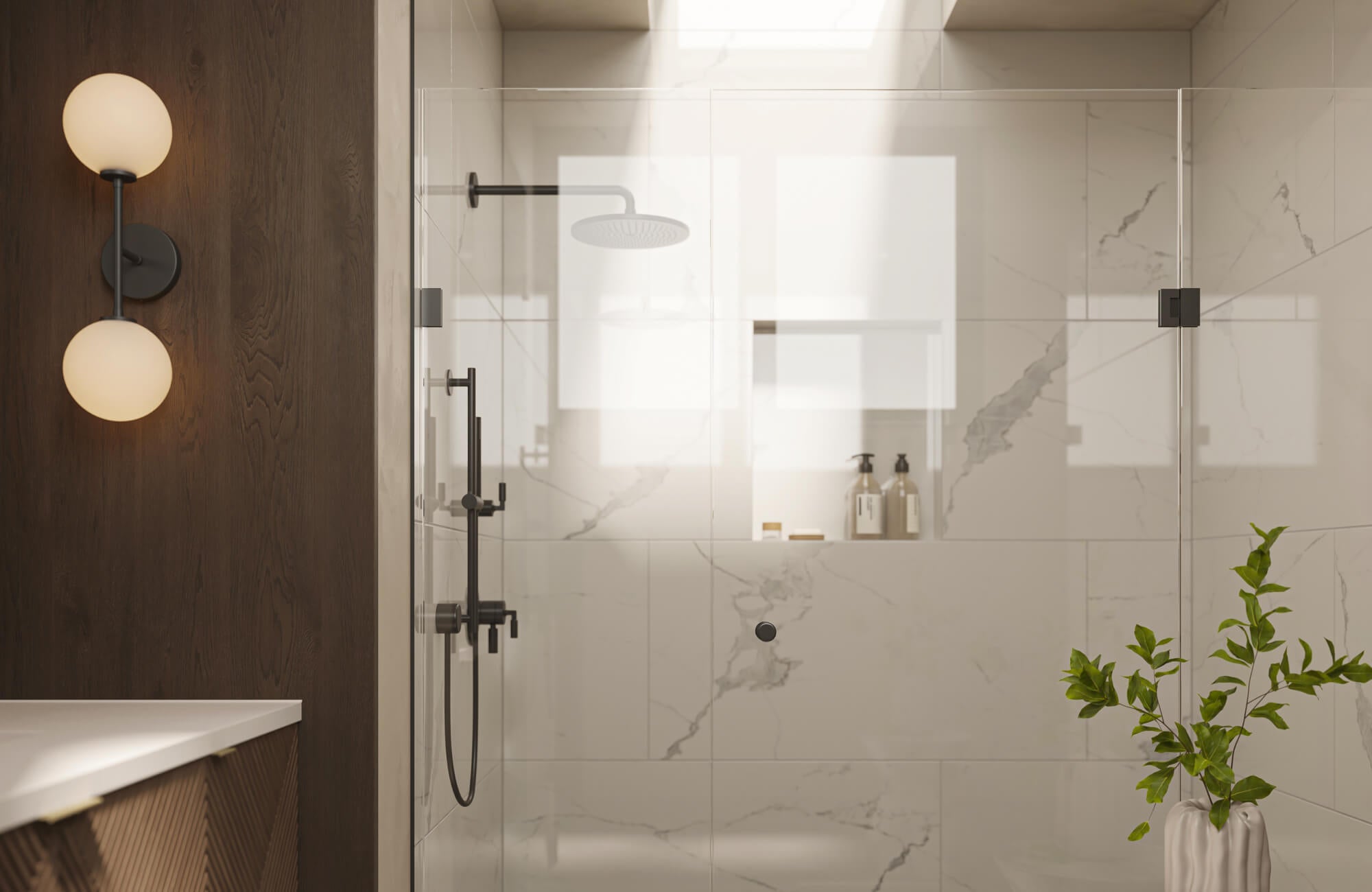 Light marble-look shower tiles paired with a glass enclosure reflect natural light, creating an open and airy shower environment.