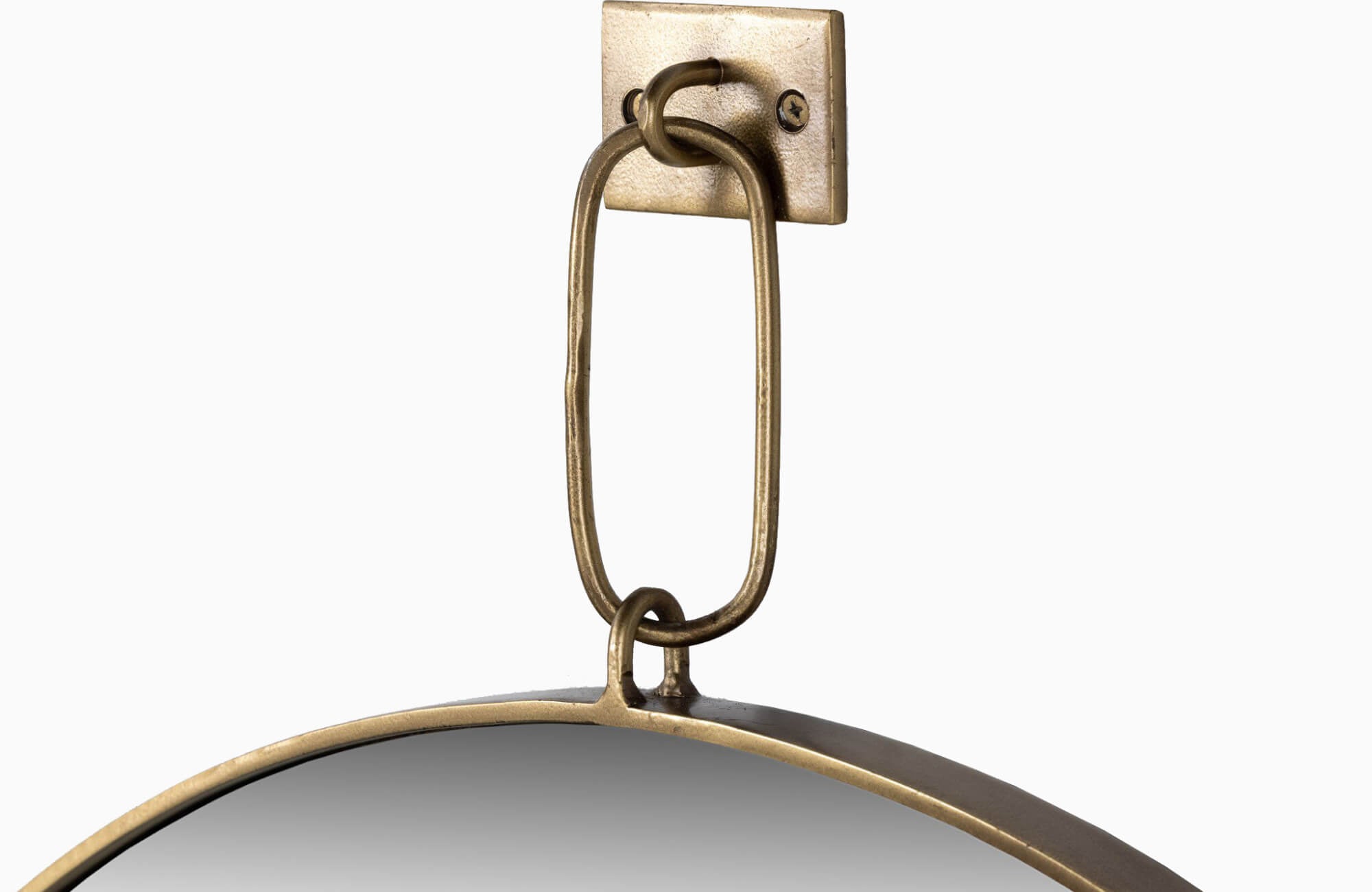 Close-up of a round framed mirror with an antique brass hanging loop and matching wall-mounted bracket.