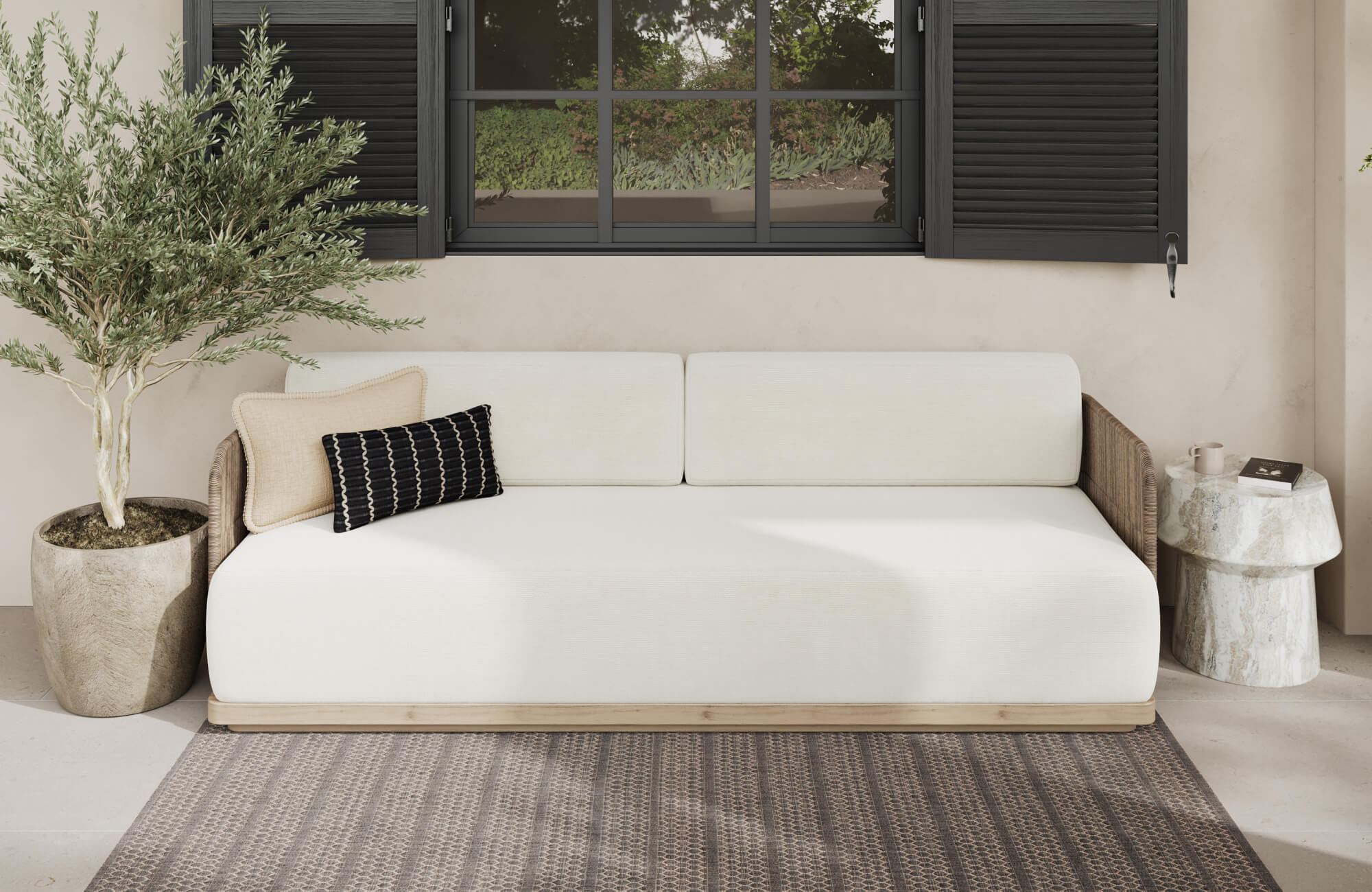 null Modern outdoor lounge with light stone tile flooring, woven wood sofa, and neutral decorative pillows beneath black shutters.
