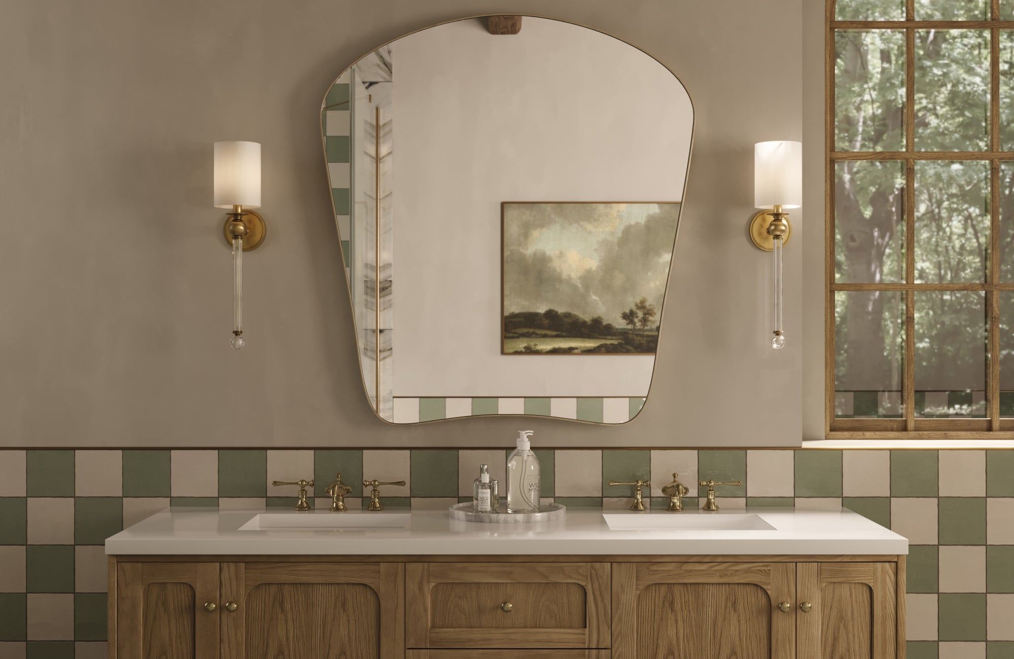 A warm bathroom with a wood vanity, brass fixtures, and soft green-and-cream checkered tile, centered by a sculptural mirror and elegant wall sconces.