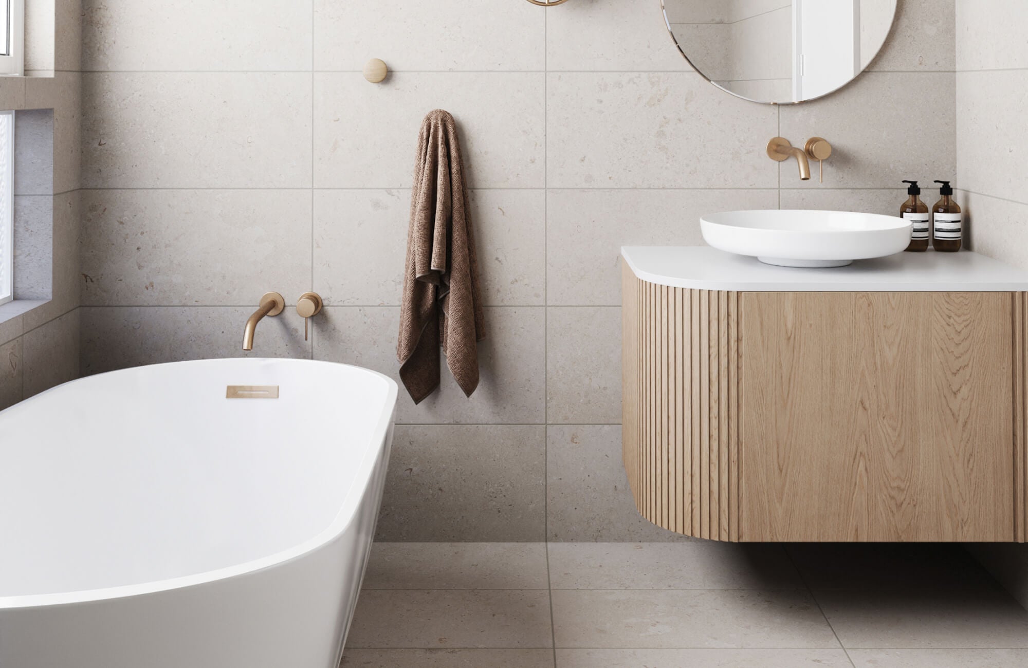 null Minimalist bathroom with large floor and wall tiles, a sleek freestanding tub, and a wood vanity with brushed gold fixtures.