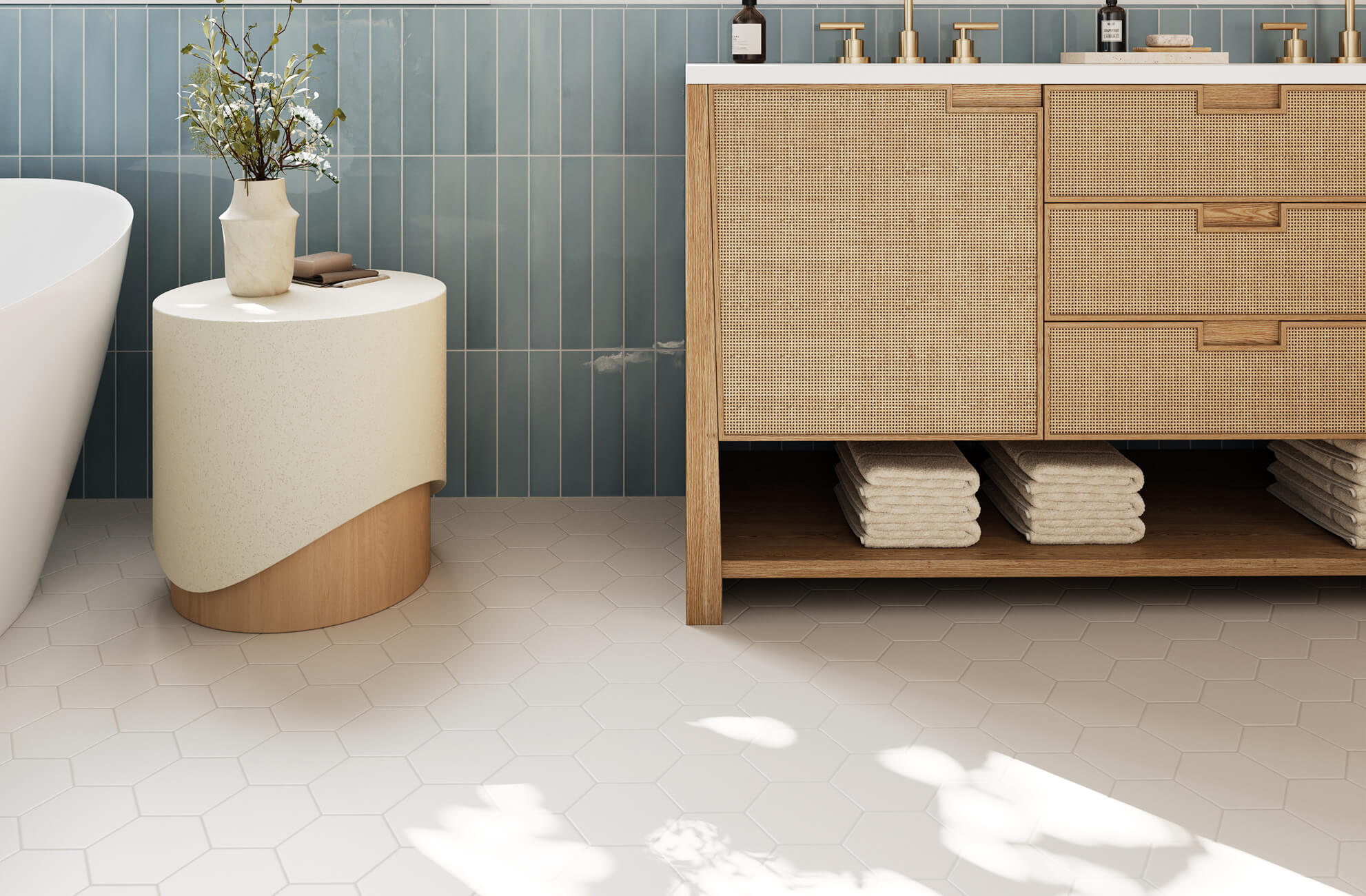 Stylish bathroom featuring matte white hexagon floor tiles paired with vertical blue wall tiles and natural wood cabinetry, creating a serene blend of modern design and organic warmth.