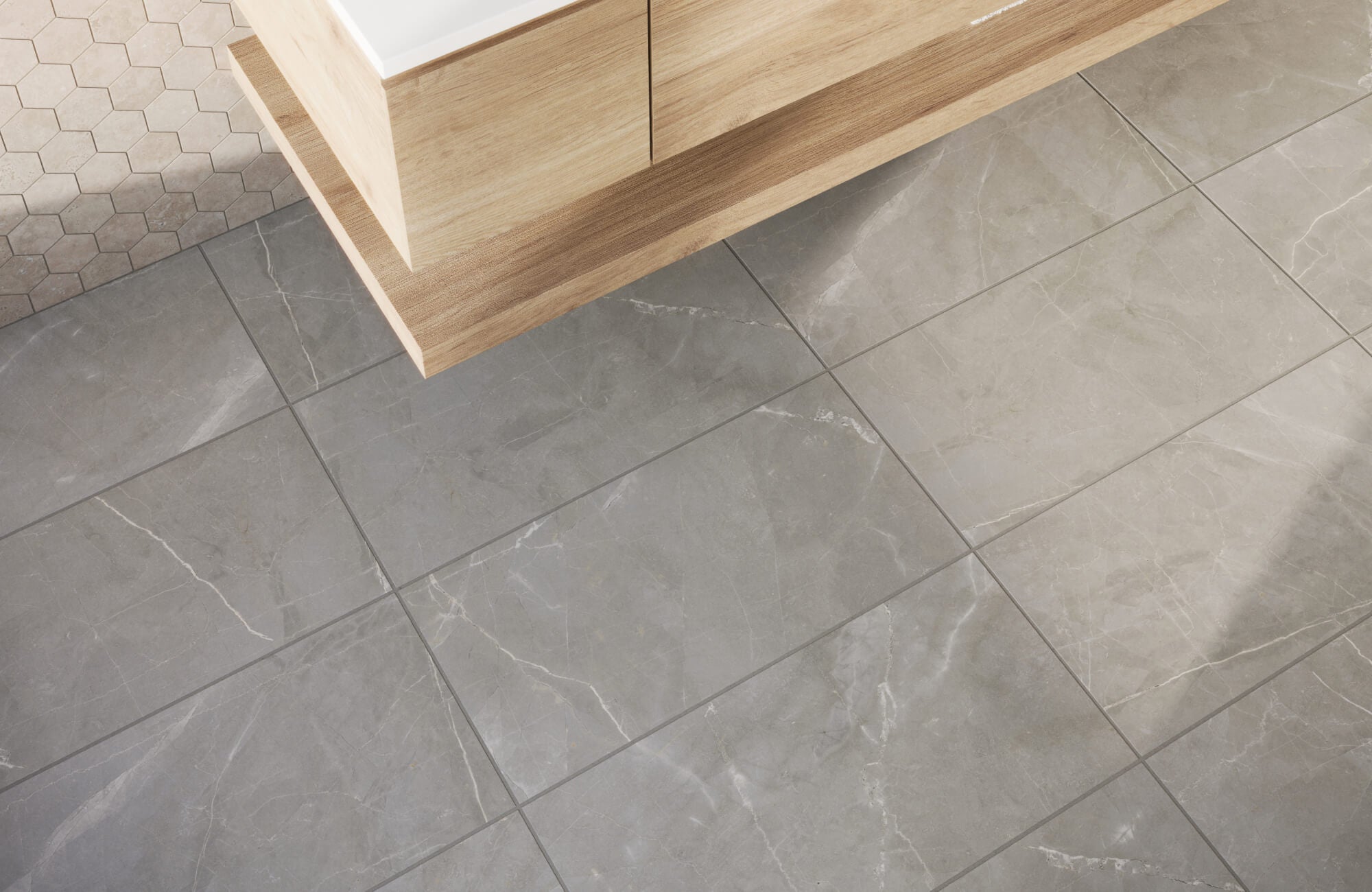 Modern bathroom with large gray marble look porcelain floor tiles featuring subtle white veining, creating a sleek and sophisticated foundation that complements the light wood vanity.