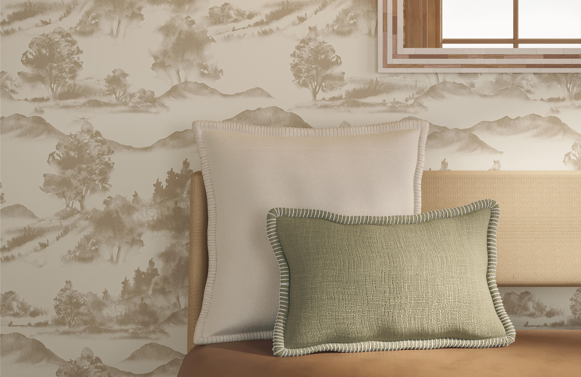 Layered pillows in beige and olive green rest against a woven headboard with soft landscape wallpaper in the background.