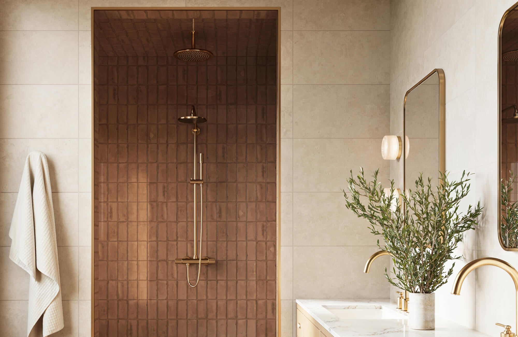 Luxurious modern bathroom with brown subway wall tiles, a gold rain showerhead in a brown tiled shower alcove, and elegant gold fixtures