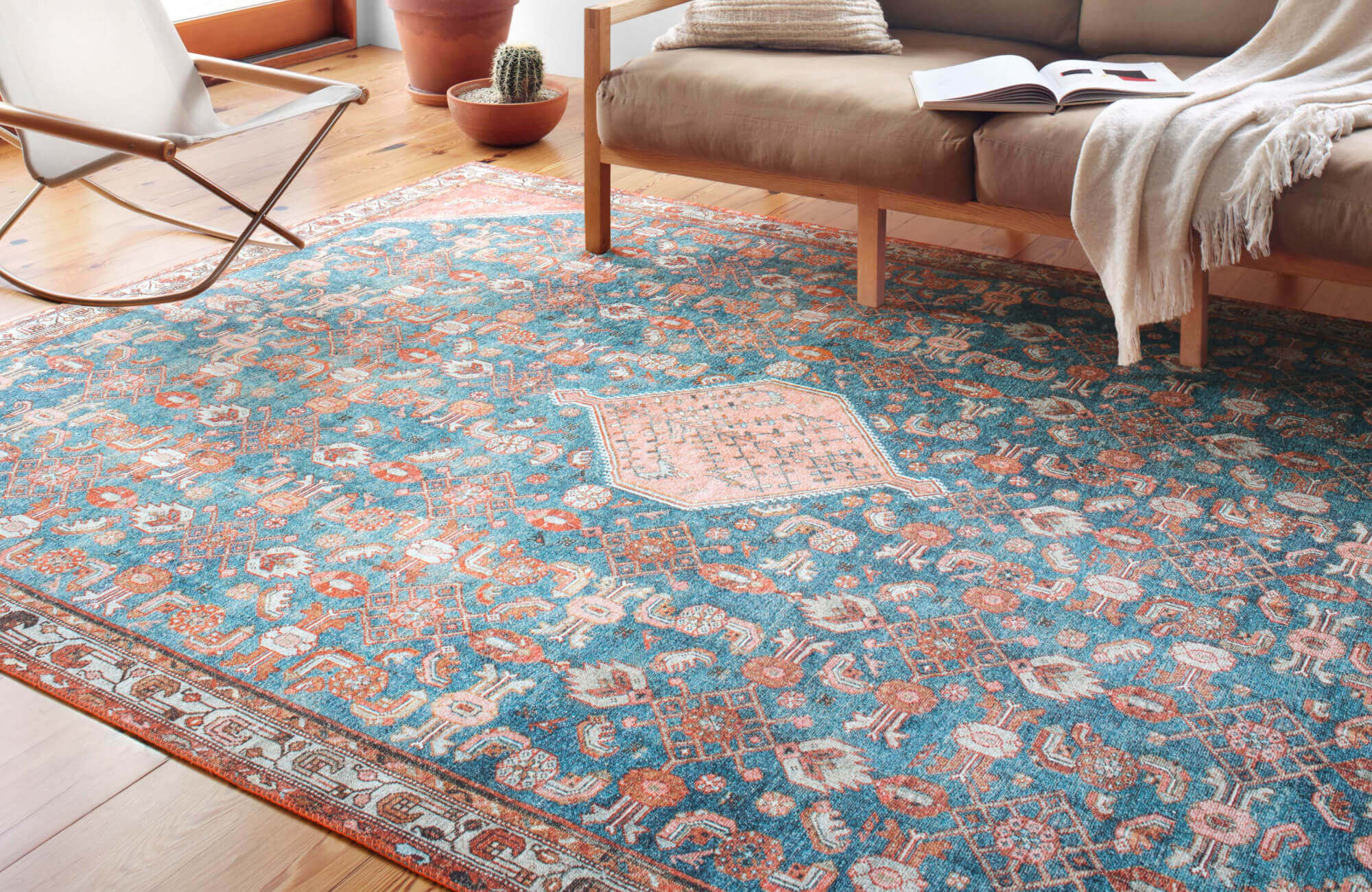 null Vibrant boho rug in blue, orange, and cream hues, bringing lively contrast to a sunlit living area.