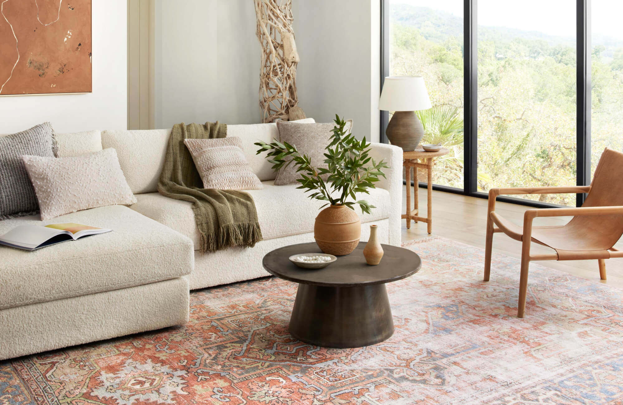 null Warm boho rug in spice red and soft blue tones, grounding a cozy living room filled with natural textures.