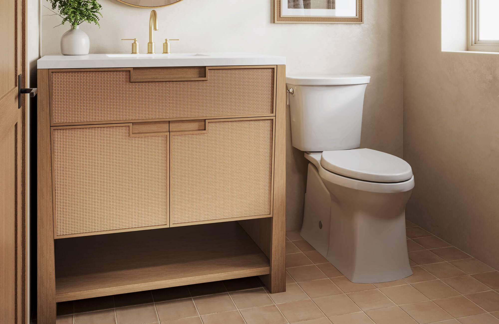 null Compact vanity with woven cane drawer fronts, brass faucet, and warm neutral tile floor in a sunlit bathroom.