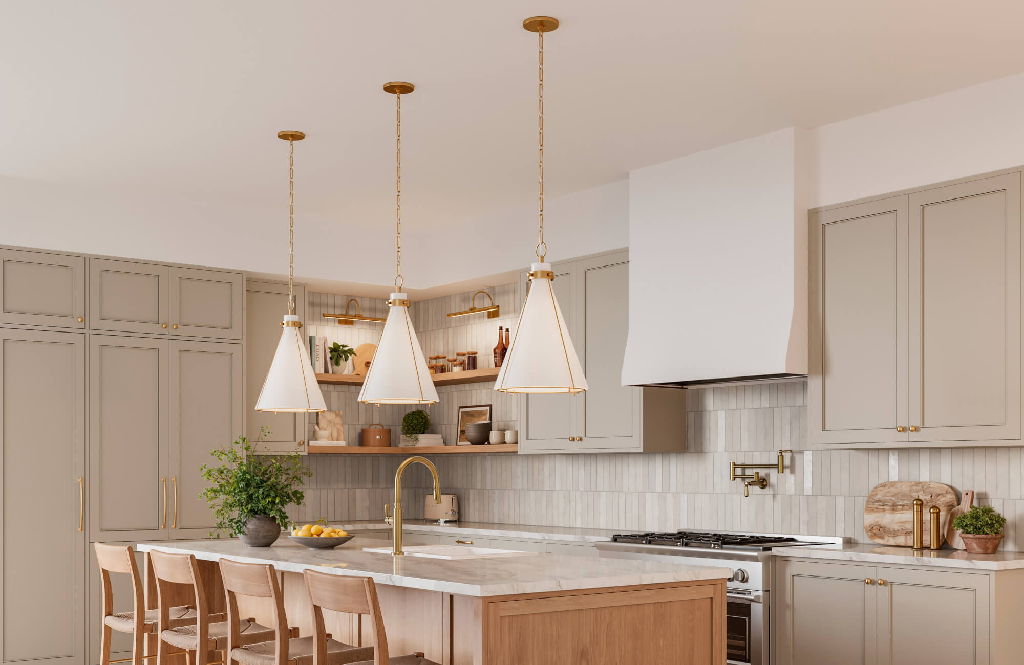 Warm kitchen with taupe cabinetry, marble countertops, and brass accents, illuminated by three cone-shaped pendant lights above the island.