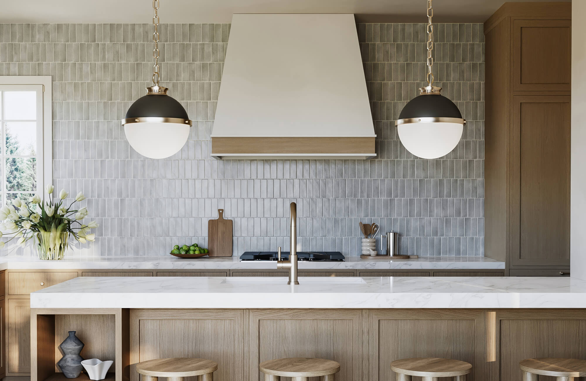 Sleek kitchen with gray tile backsplash, marble counters, and wood cabinetry, highlighted by two globe pendant lights above the island.