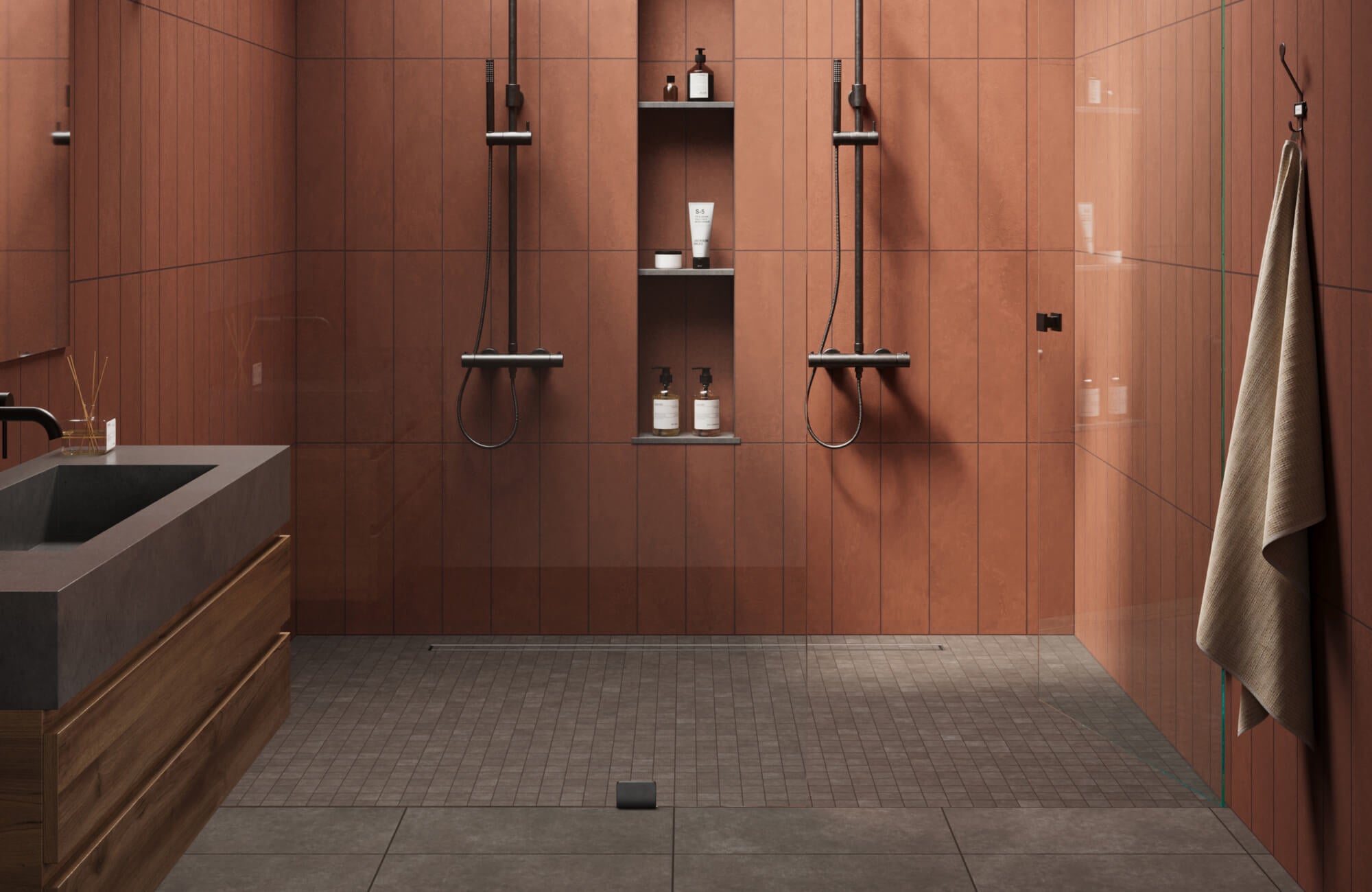 Modern shower with matte brown wall tiles, black fixtures, built-in niche shelving, and textured mosaic floor tiles.