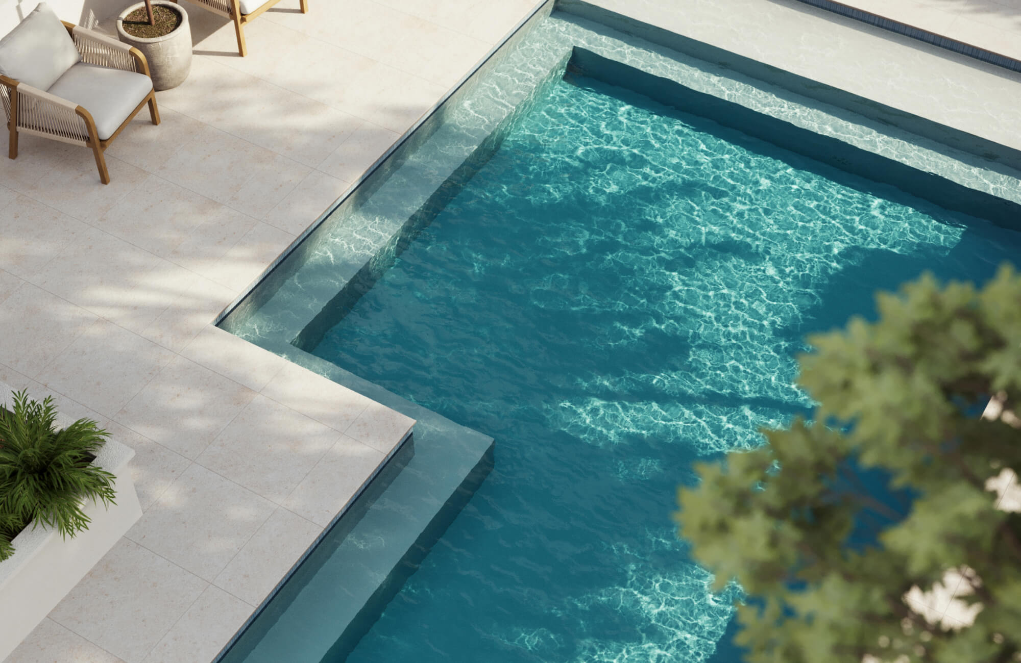 null Modern outdoor pool area featuring beige stone-look paver tiles that frame the clear blue water, creating a refined, resort-inspired setting ideal for relaxing and entertaining.