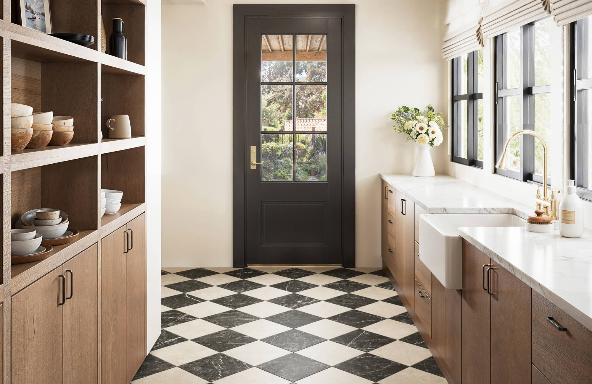 null Checkerboard tile floor in black and cream marble adds timeless elegance to a bright, modern farmhouse kitchen.