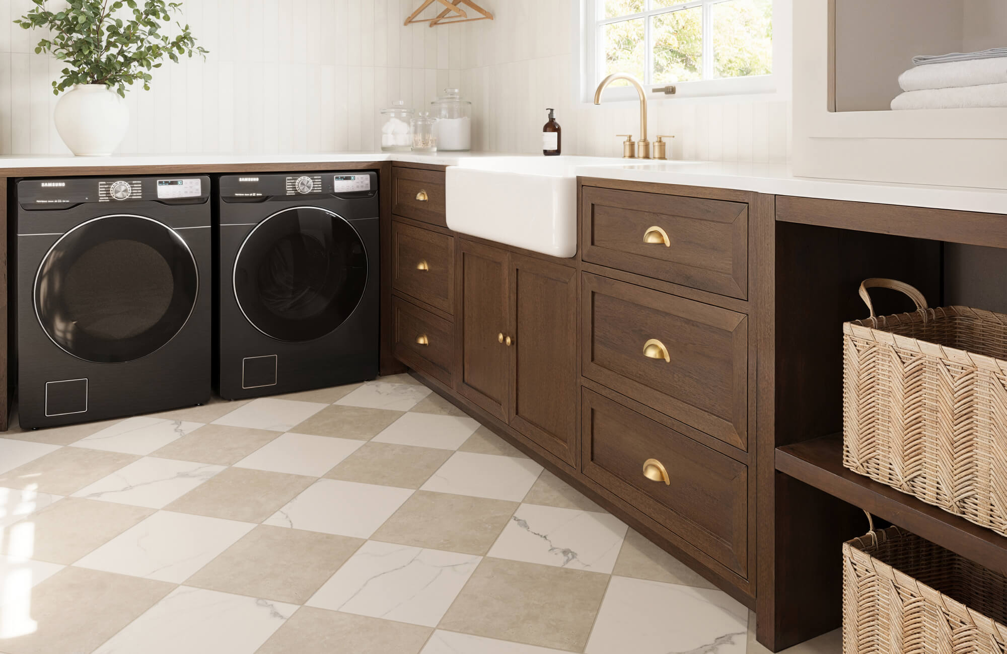 Charming laundry room with checkered marble-look tiles, rich wooden cabinetry with brass hardware, and modern black appliances for a refined touch.