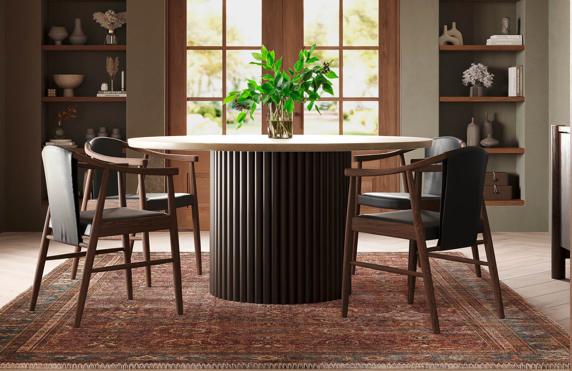 Contemporary dining room with a fluted round pedestal table, leather and wood armchairs, and a vintage-style rug grounding the space.