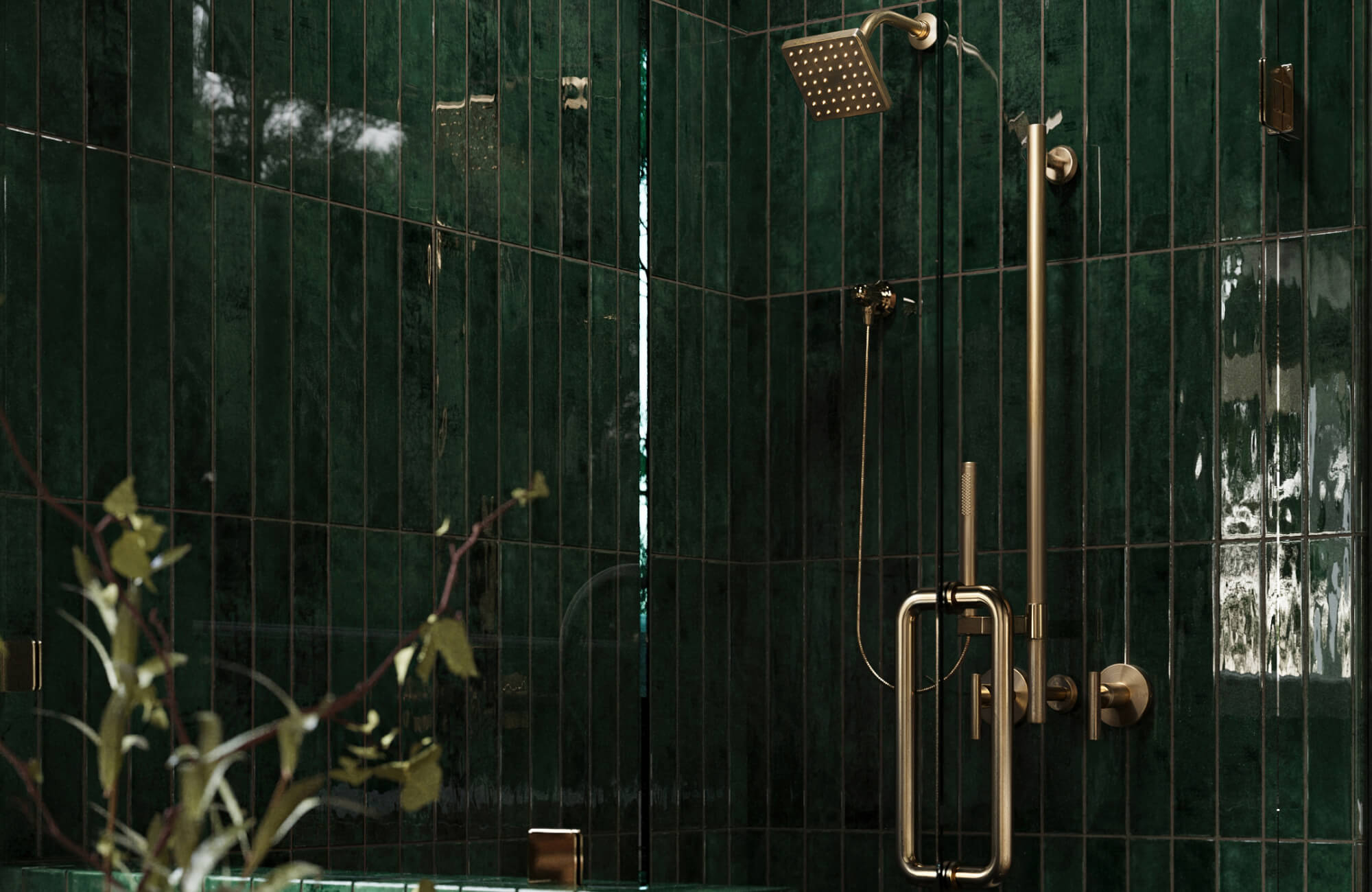 null Shower area with dark green glossy wall tiles and brass fixtures, highlighting a bold modern bathroom tile color.