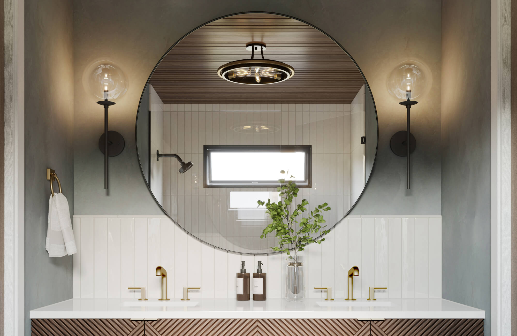A large wall mirror with a sleek round silhouette centers the modern bathroom, reflecting warm lighting, brass fixtures, and clean tile surfaces to create a balanced, contemporary, and spa-like atmosphere.