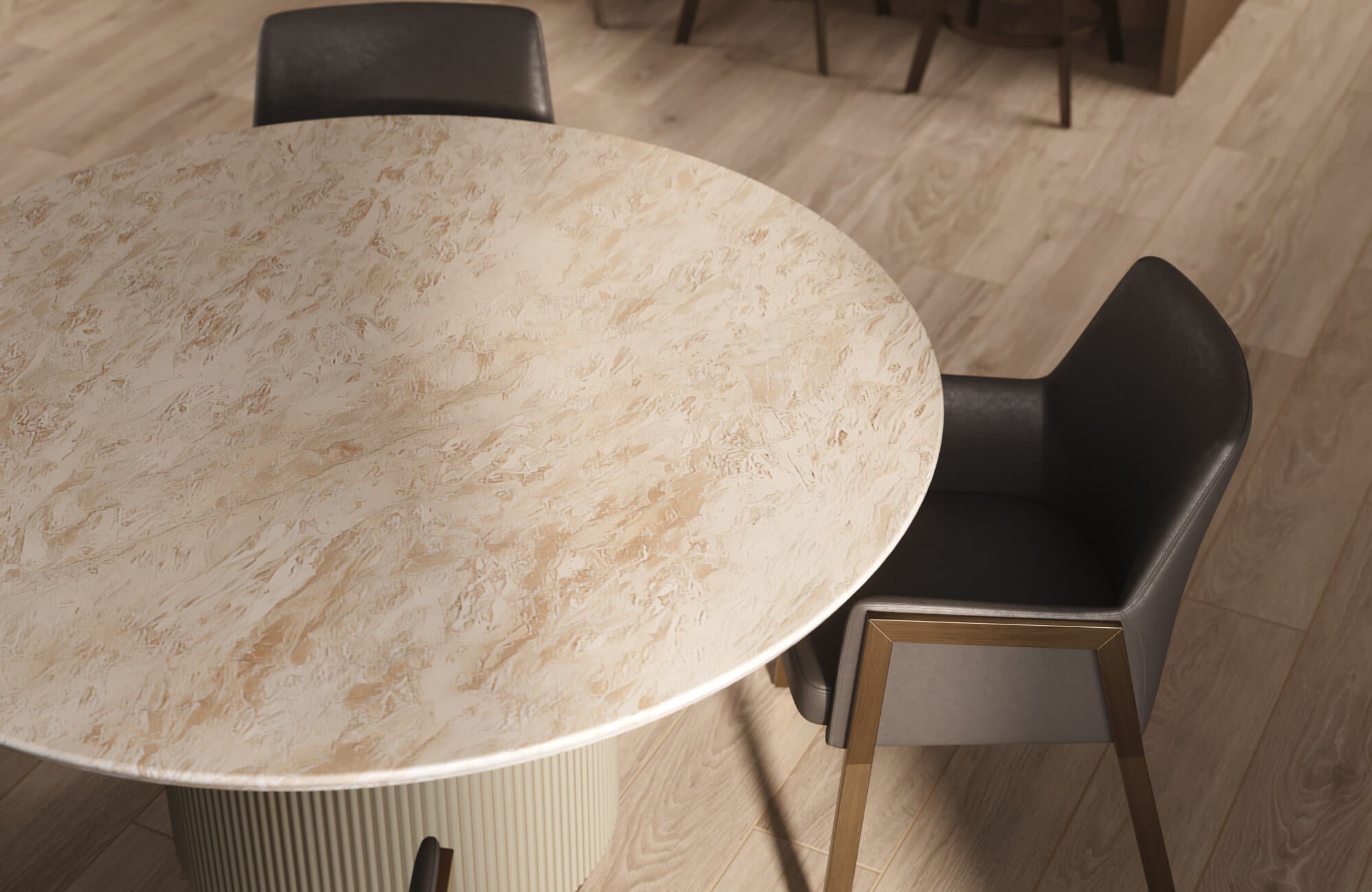 null Close-up view of a round marble-look engineered stone dining table with a textured beige surface, paired with sleek black and wood-accented chairs, showcasing a refined alternative to a true marble dining table.