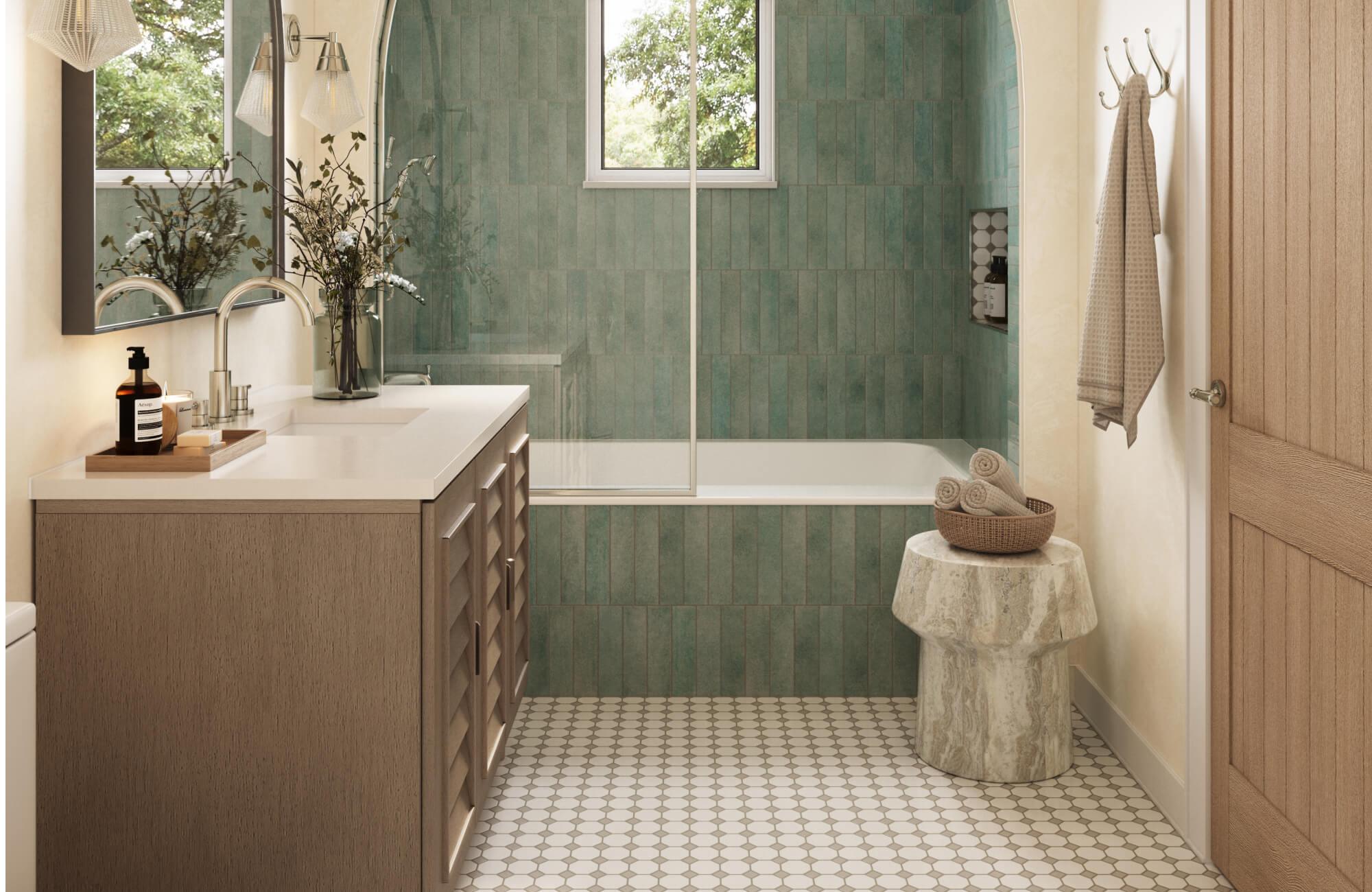 Serene, spa-inspired bathroom featuring soft green vertical wall tile, a warm wood vanity, and a light neutral penny round tile floor that adds timeless texture and gentle contrast to the space.