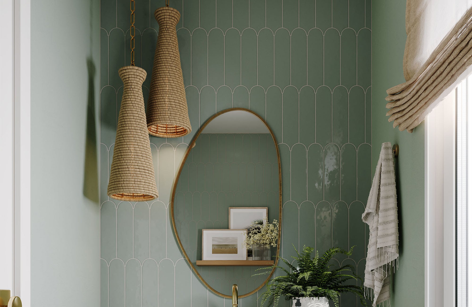 null Pendant lights with woven shades add warmth and vertical interest to a green tile bathroom with an oval mirror.