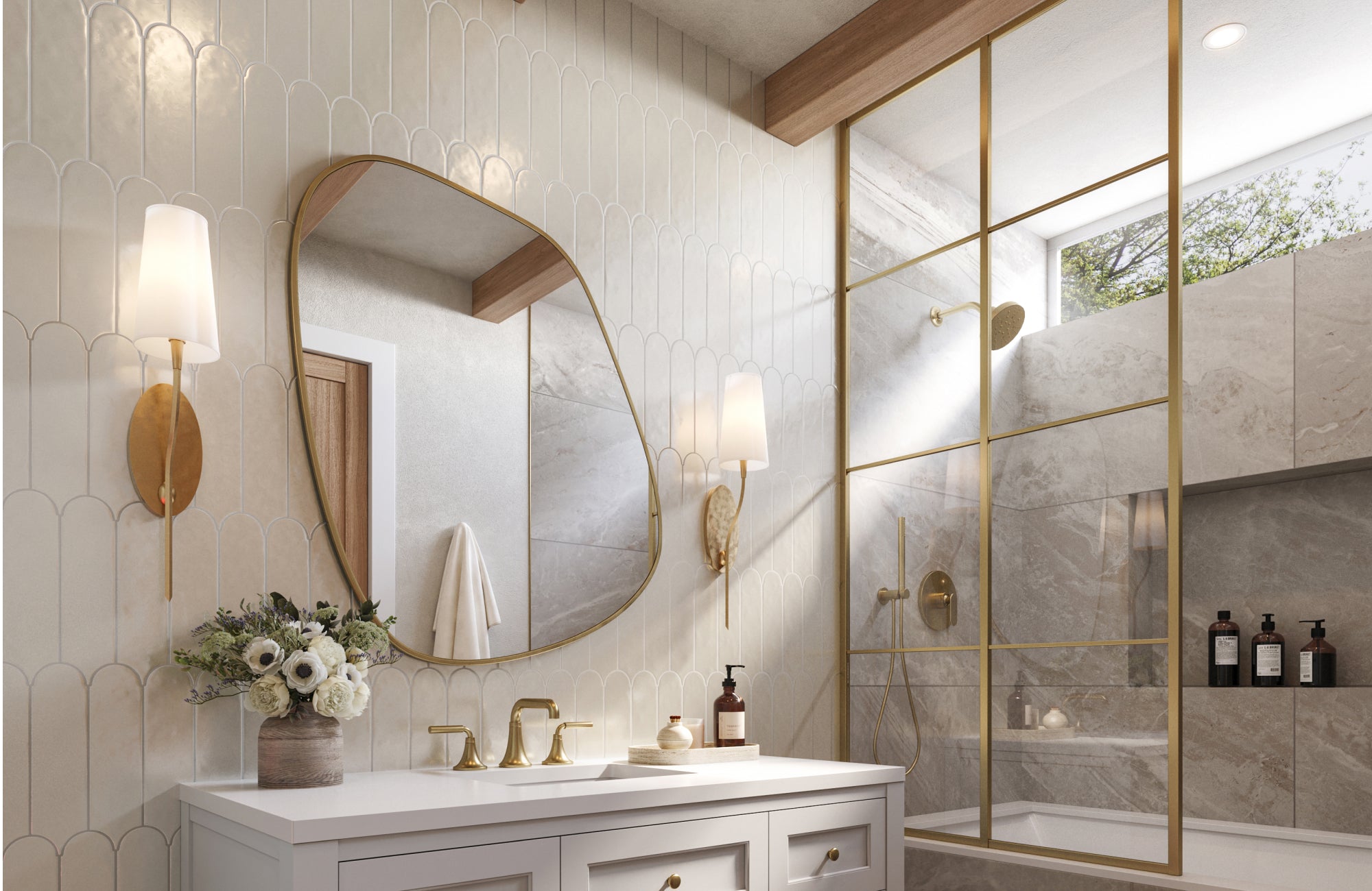 Asymmetrical mirror with brass trim, mounted above a classic white vanity with brass faucets and wall sconces.