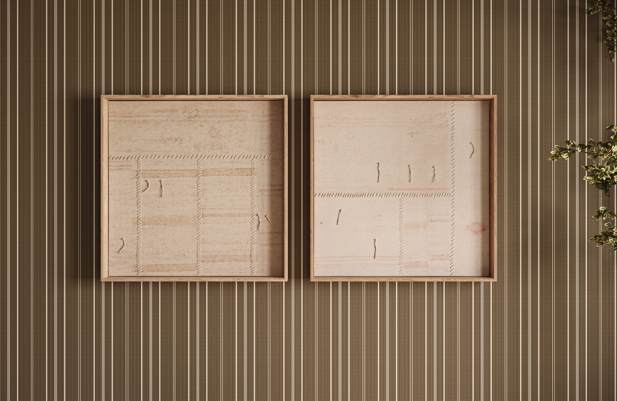 null Subtle stitched patterns and natural fabric textures create a gallery-style wall art display, framed in light wood against striped wallpaper in warm brown tones.
