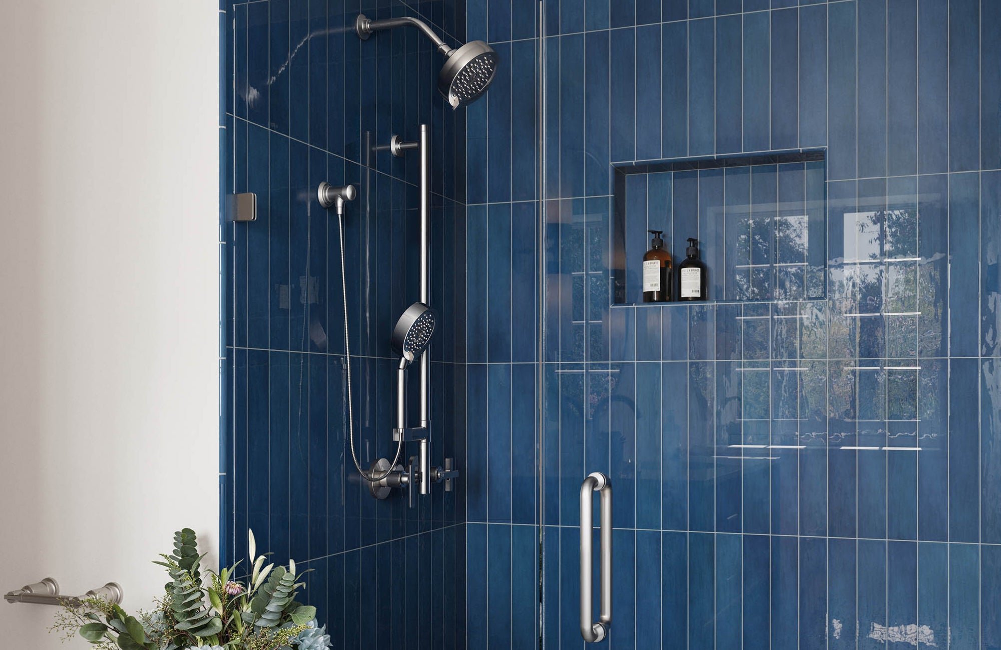 Glossy royal blue shower tiles with brushed nickel fixtures and monochrome flooring for a crisp, modern contrast.
