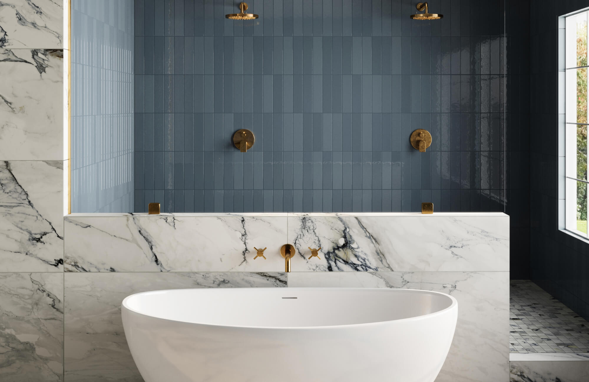 A luxurious bathroom with deep blue glossy shower subway tiles, marble look tile accents, a freestanding tub, and brass fixtures, creating a serene, elegant retreat.