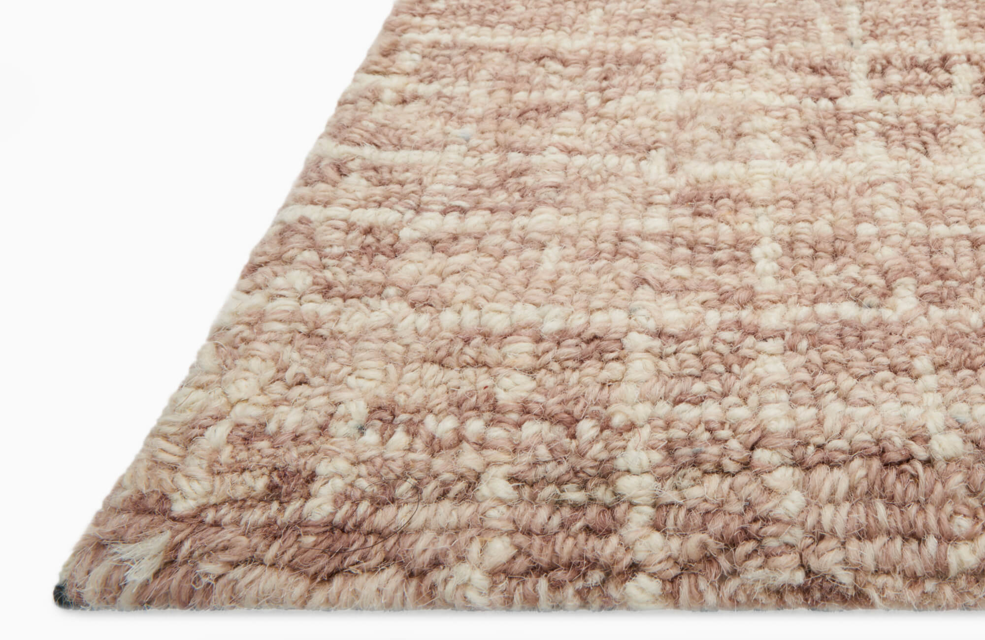 Textured close-up of a blush and cream handwoven wool rug with a thick checkered weave, ideal for warming up modern minimalist interiors
