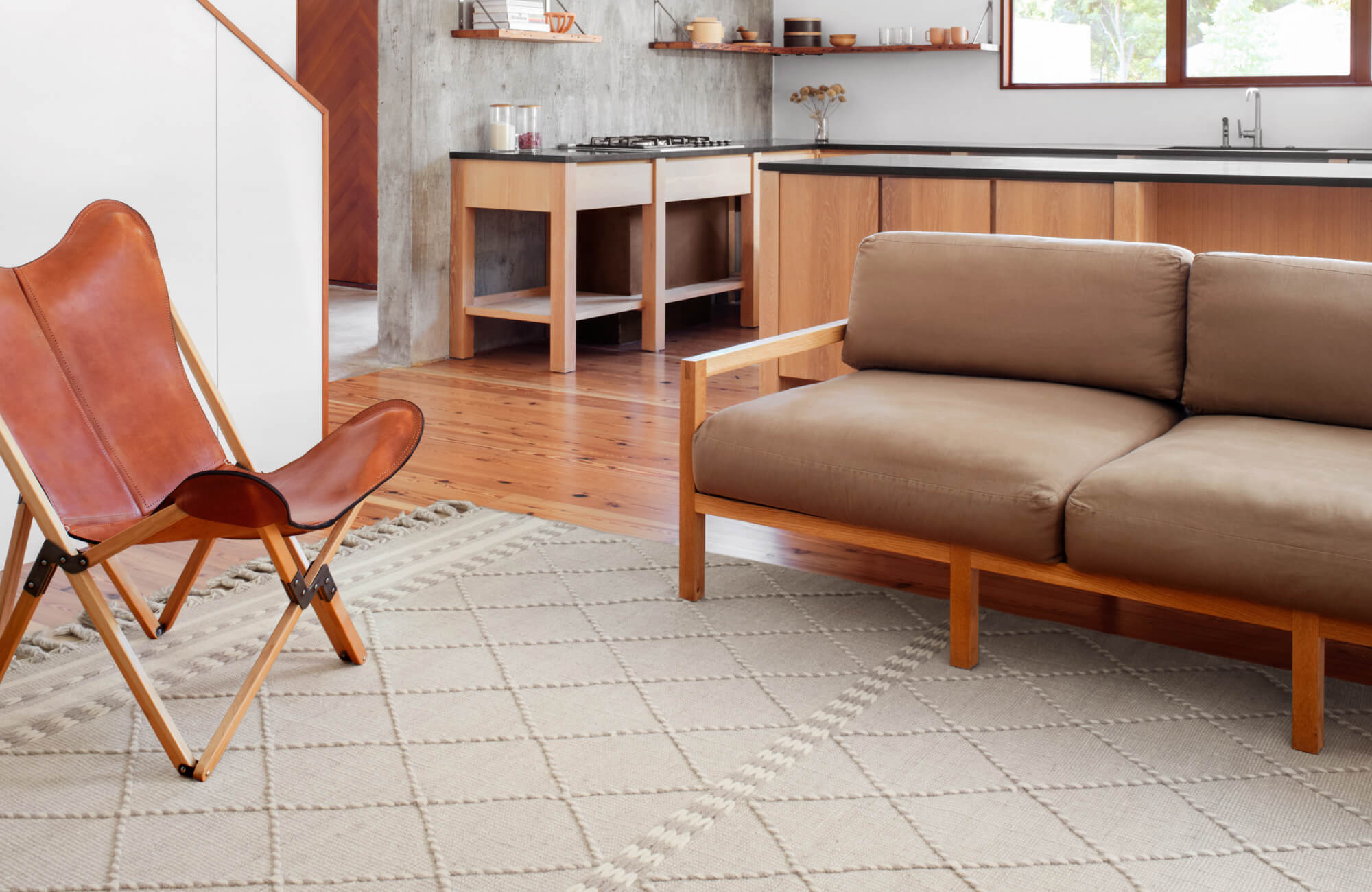 null White arabesque floor tiles with a distressed runner rug create a bright yet grounded laundry room aesthetic.