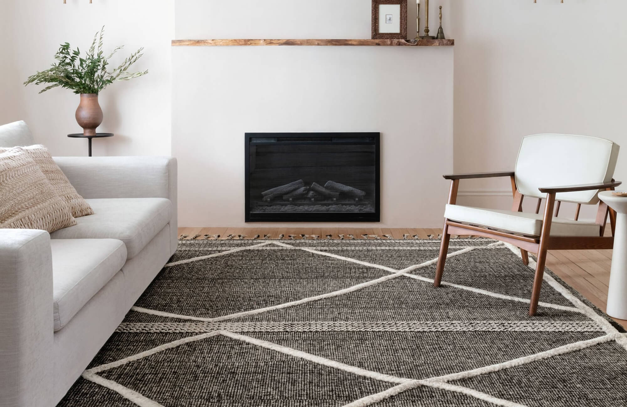 null Charcoal rug with ivory crisscross pattern adds bold contrast and texture to this warm, minimalist living room.