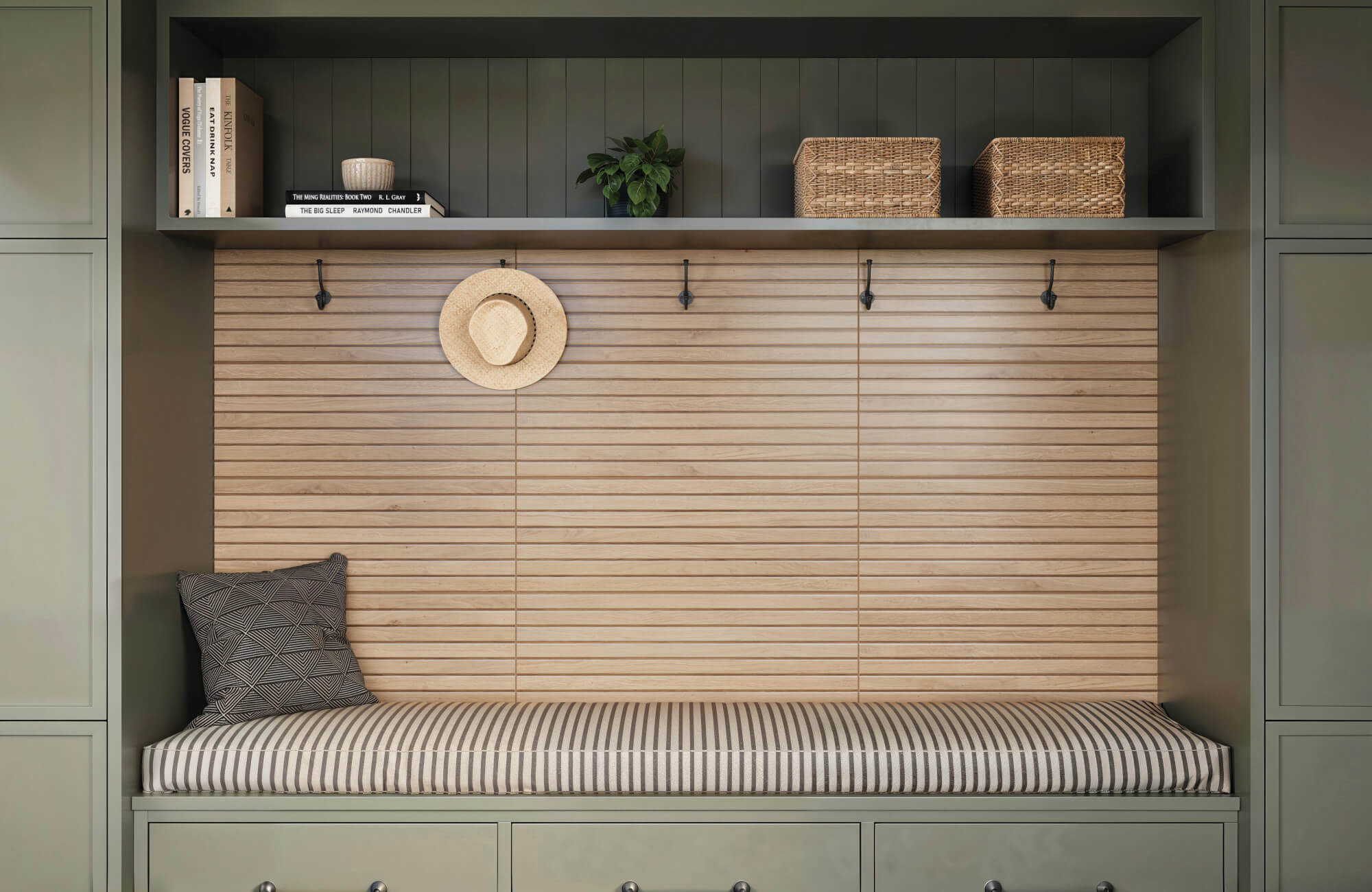 Entryway nook with sage green cabinetry, striped cushion bench, and wood slat tile accent wall paired with natural woven baskets