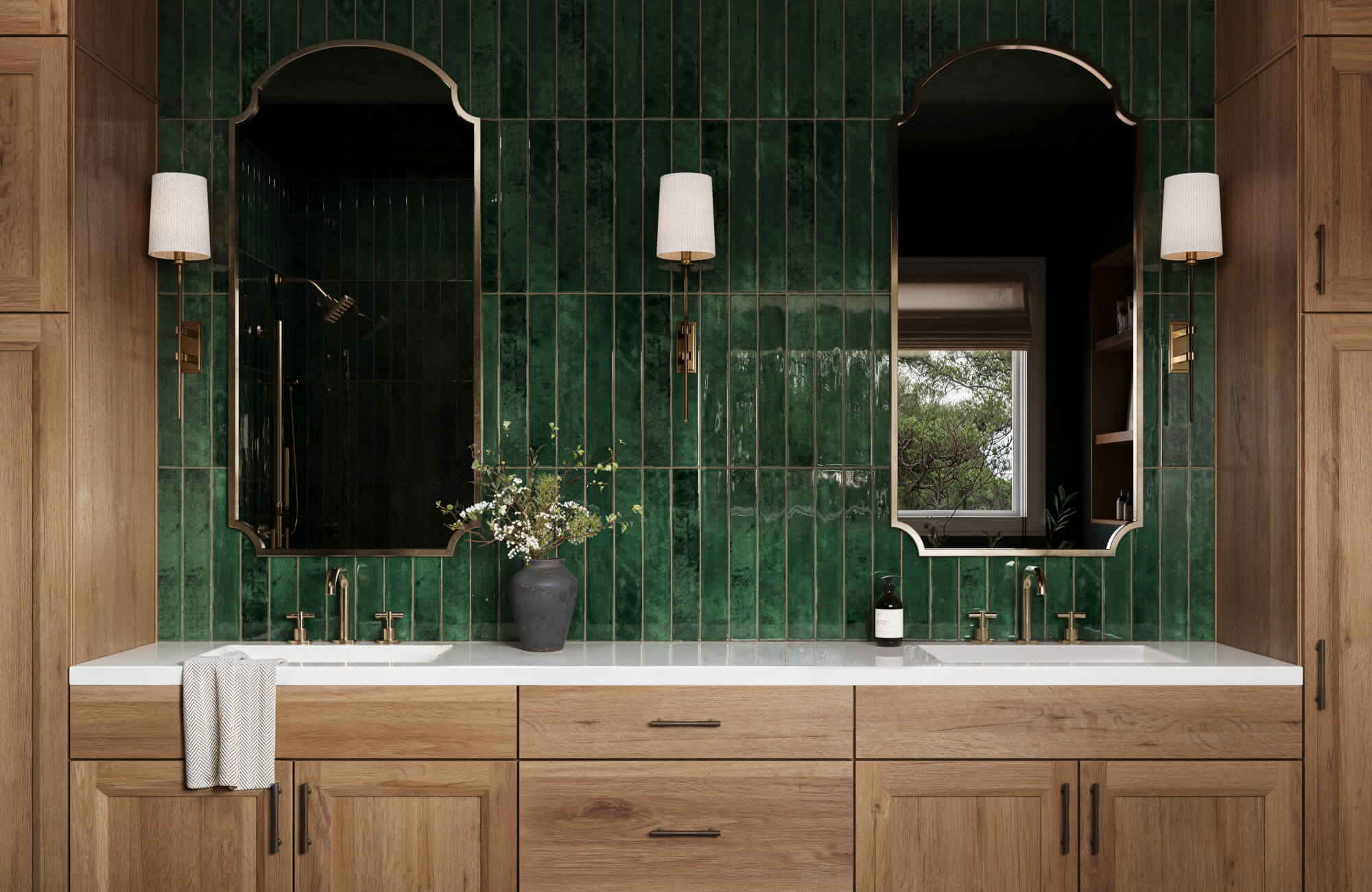 null Glossy, deep emerald green subway tiles paired with natural wood cabinetry and arched mirrors create a bold and elegant bathroom design.