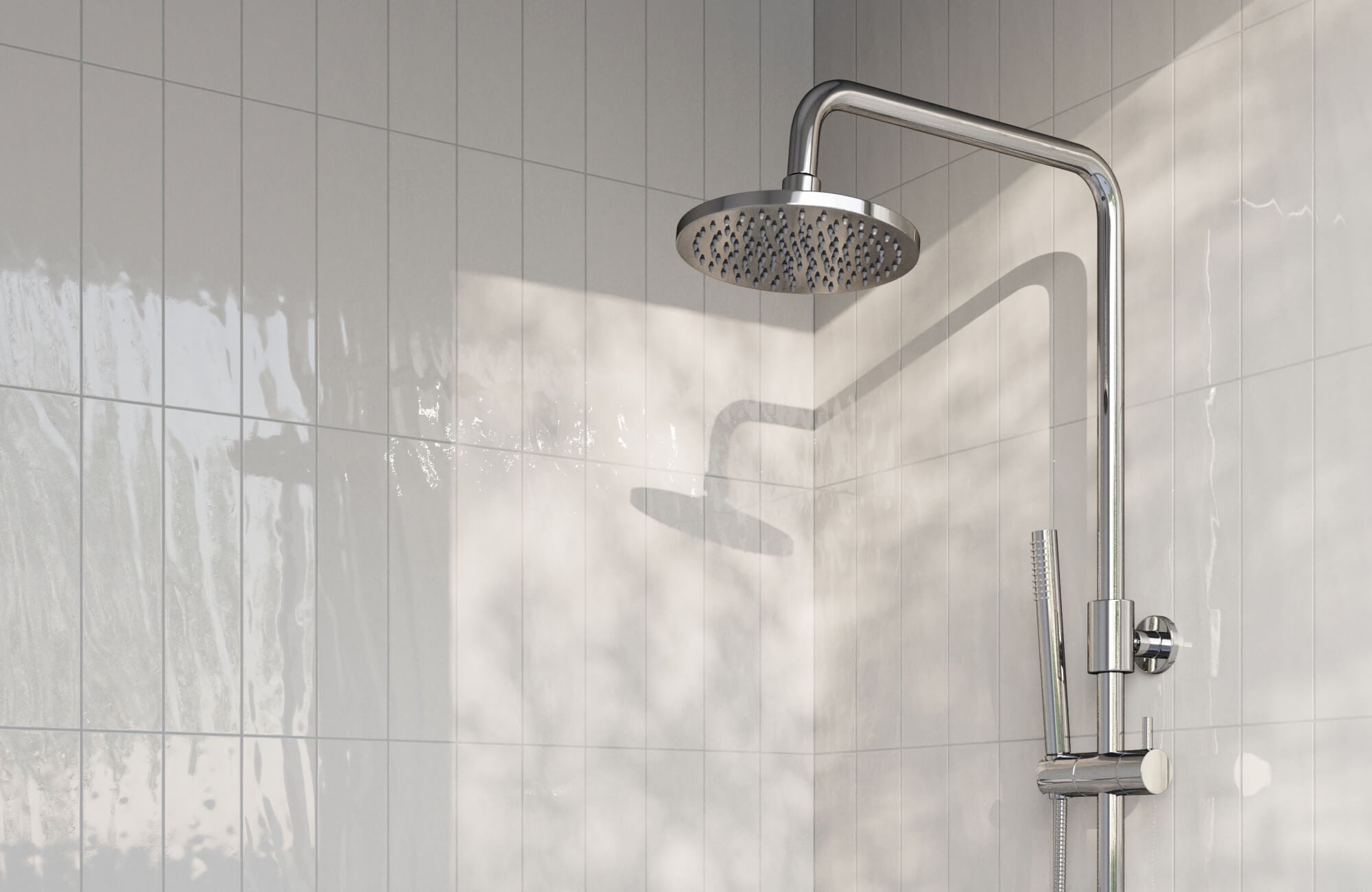 White subway tiles with soft grey grout in a shower reflect natural light for a clean, tranquil, and modern finish.