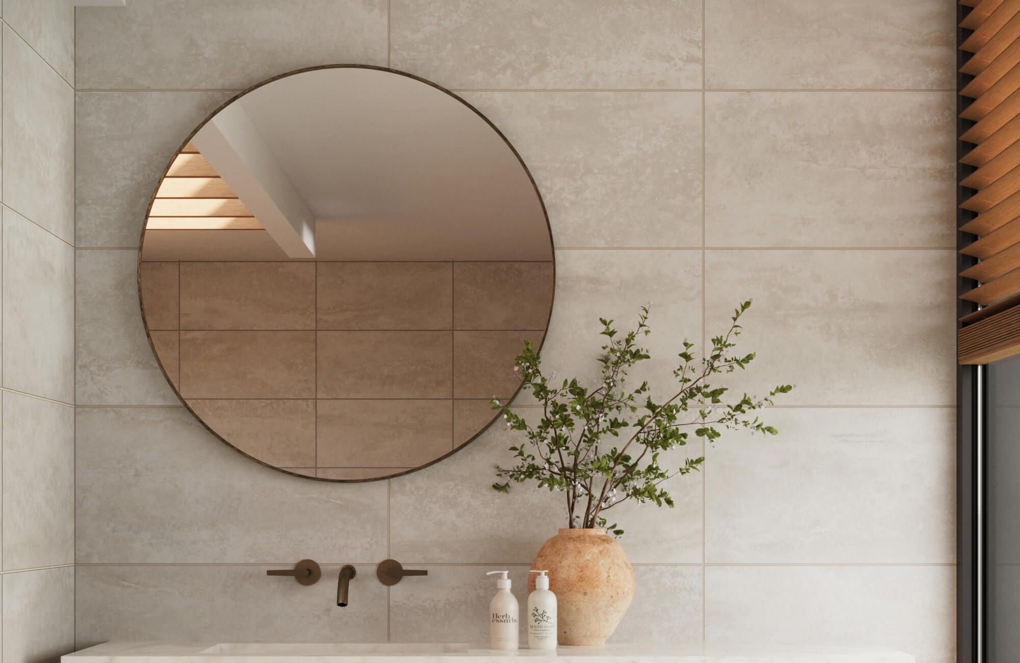 null Elegant bathroom vanity with round mirror, beige tile walls, and natural decor including a vase with greenery and soap bottles.