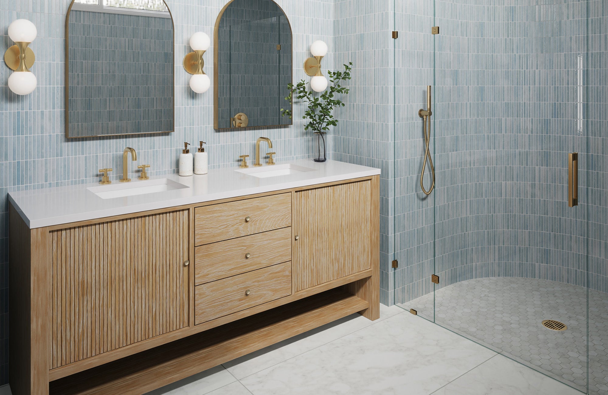 null Dual globe sconces in brass flank arched mirrors above a wood vanity in a blue tile walk-in shower bathroom.