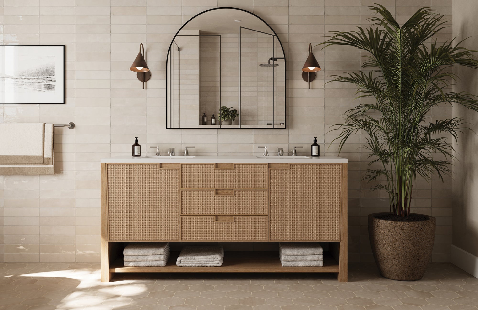 null Cone-shaped bronze wall sconces paired with an arched mirror over a natural rattan-front vanity in a soft-toned bathroom.
