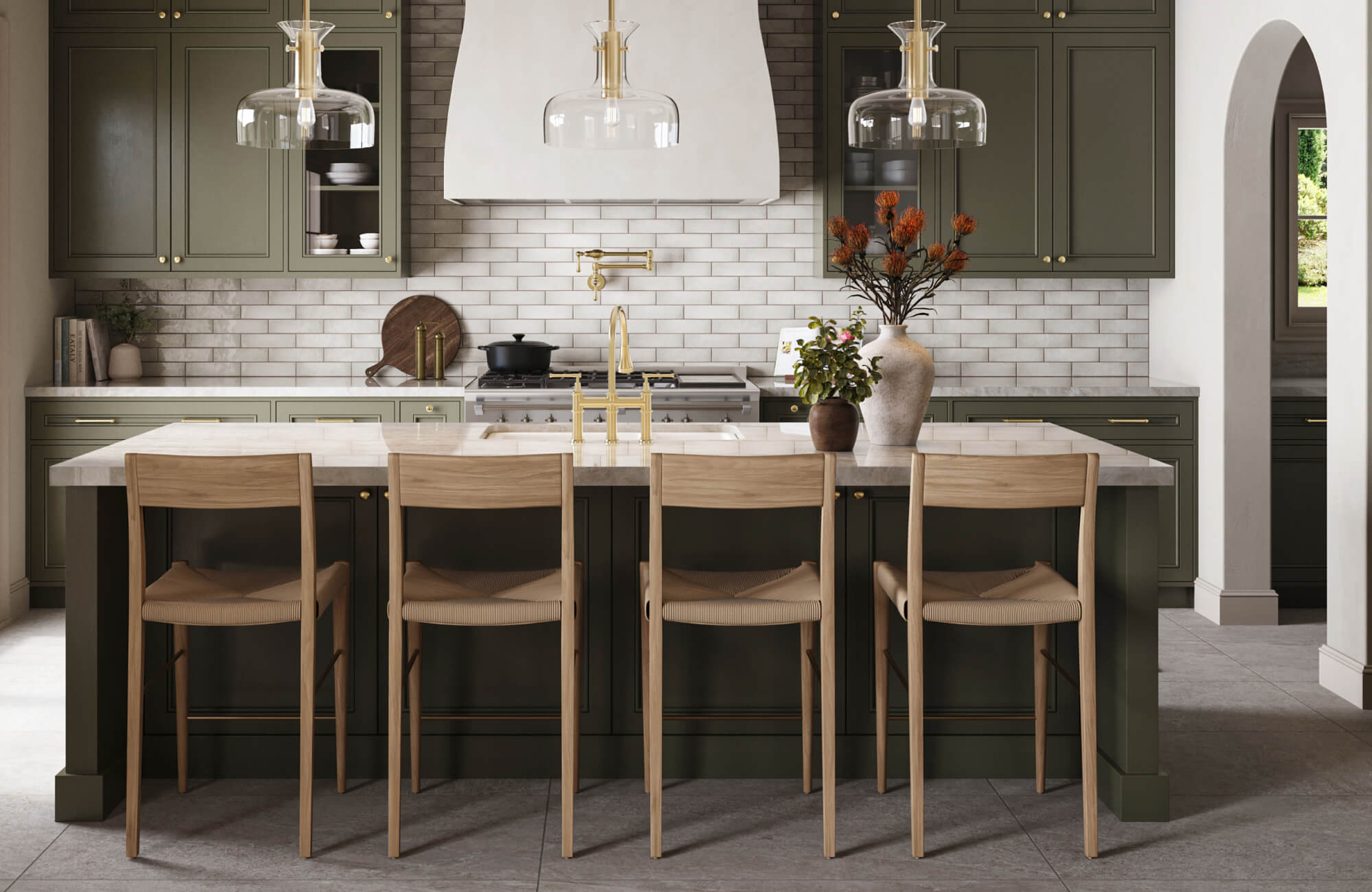 null Refined, modern farmhouse kitchen featuring a marble island styled as a counter height dining set with four woven-seat wooden stools, complemented by sage green cabinetry, white subway tile backsplash, brass fixtures, and glass pendant lighting.