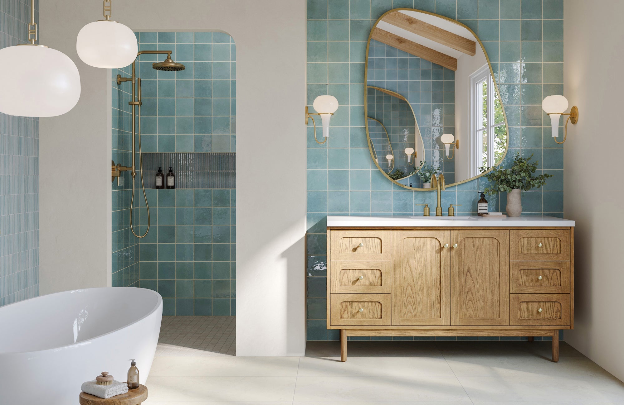 null Oversized oval mirror with brass trim above a light wood vanity, set against glossy turquoise square tile