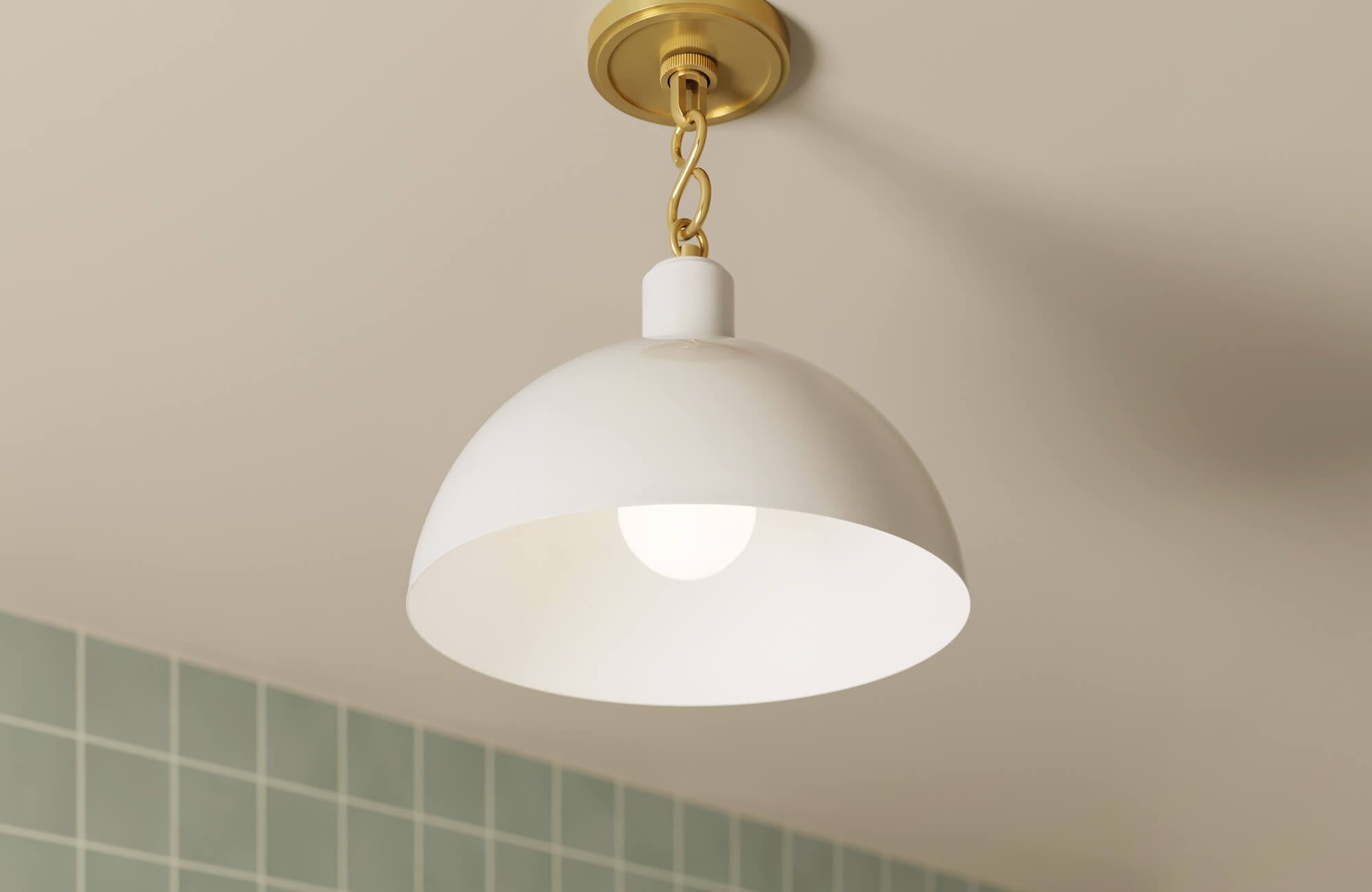 null Modern white hanging light fixture with gold hardware, installed over a tiled bathroom wall.