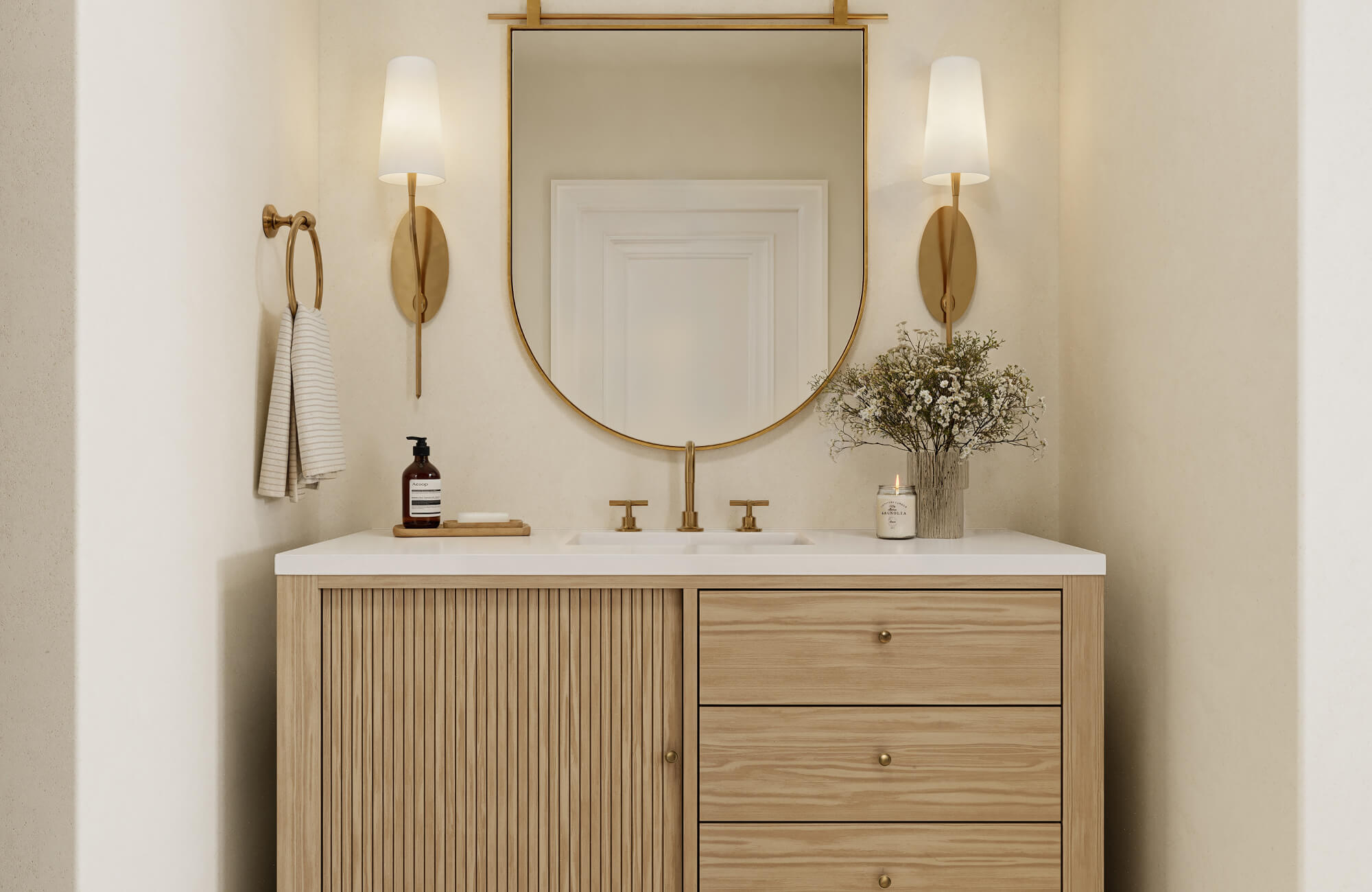 null Modern vanity with gold fixtures, white countertop, and glowing wall lights framing a round mirror.