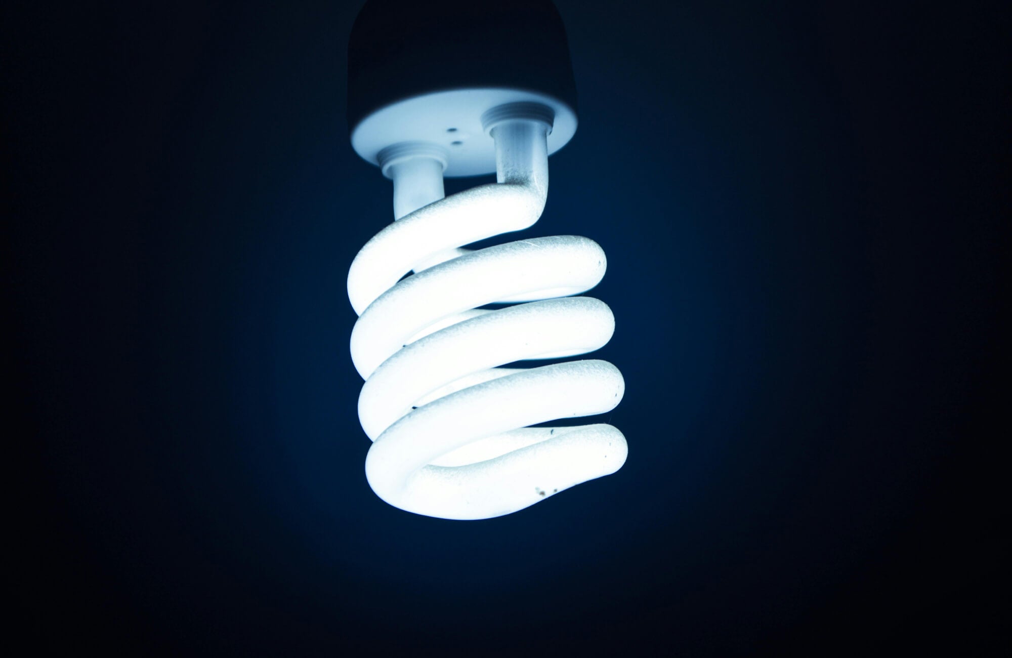 null Bright compact fluorescent lamp with crisp white light, highlighting its spiral shape.