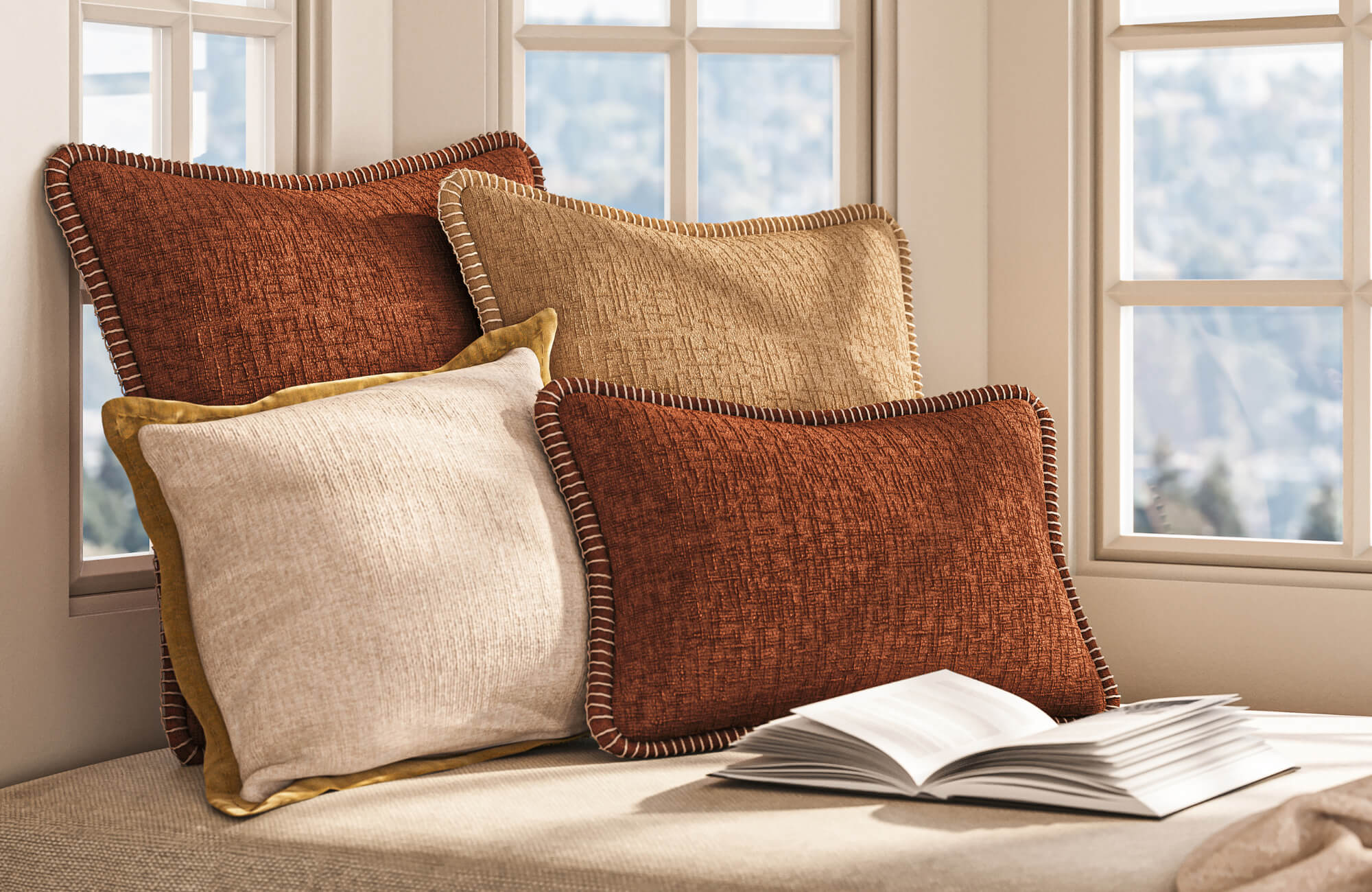 Window seat styled with decorative pillows in earthy tones and varied textures, demonstrating layered arrangement for a cozy, refined look.
