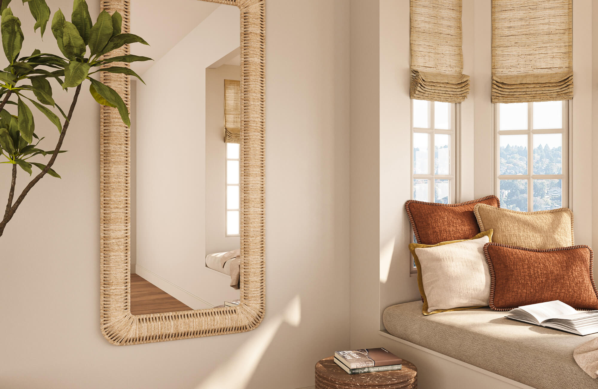 Bright corner with woven mirror and window bench featuring layered decorative pillows, highlighting texture mix and soft neutral palette.