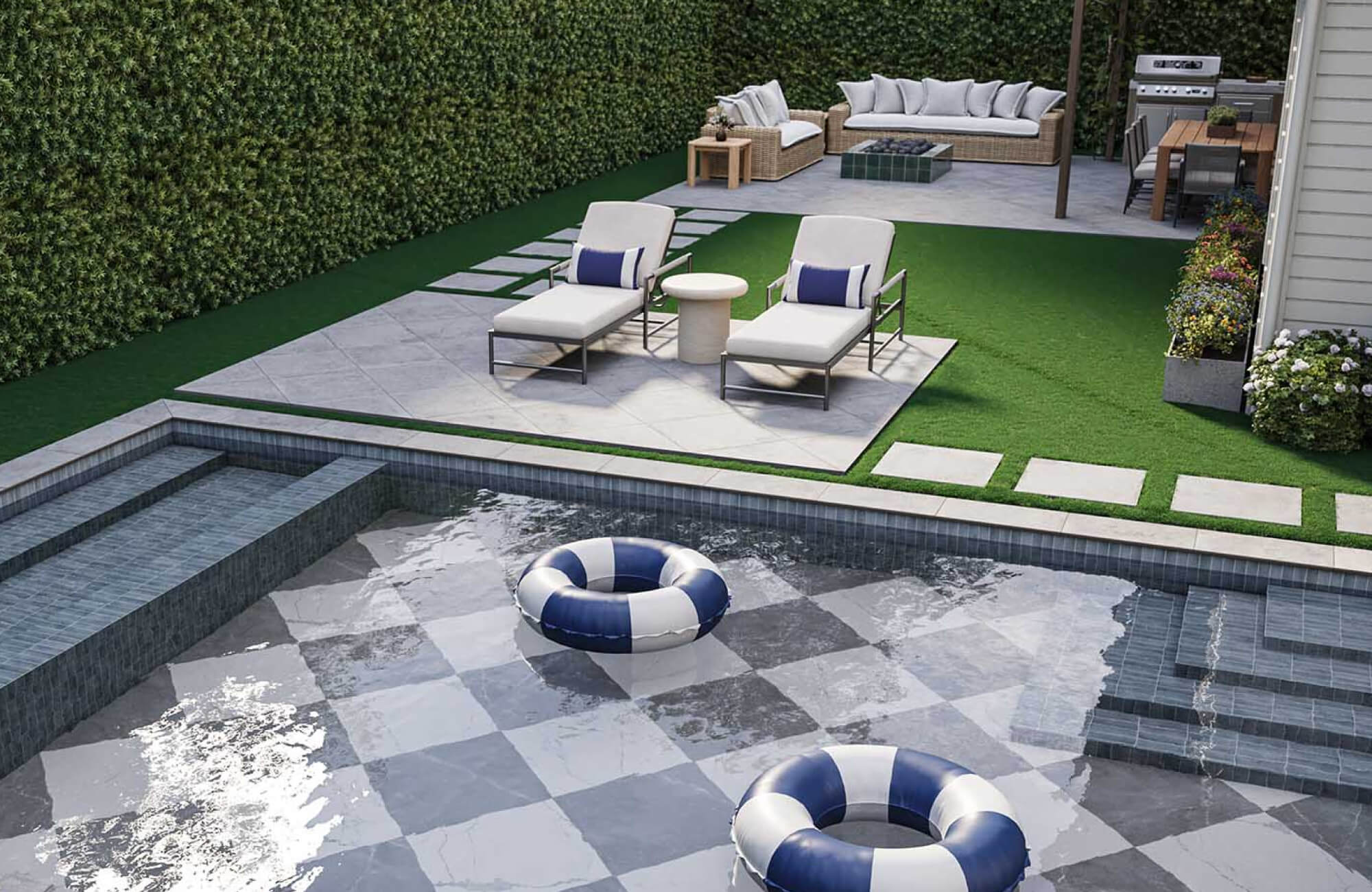 null Light gray cushioned chaise lounges with black metal frames and navy accent pillows beside a dark tiled swimming pool with geometric stone decking and tall privacy hedges