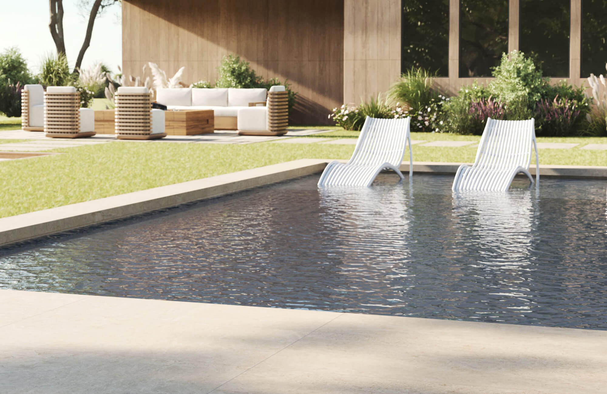null White in-pool loungers placed inside a dark reflective swimming pool beside warm wood outdoor seating, neutral cushions, landscaped garden borders, and a modern wood-clad home