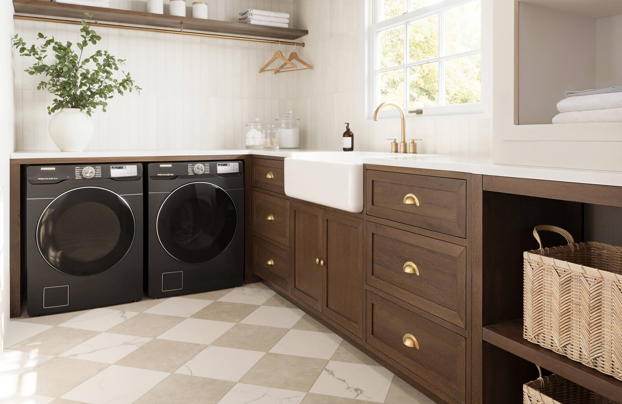 null Bright utility room featuring warm wood cabinets, gold fixtures, and checkered tile flooring paired with a farmhouse sink and modern appliances.