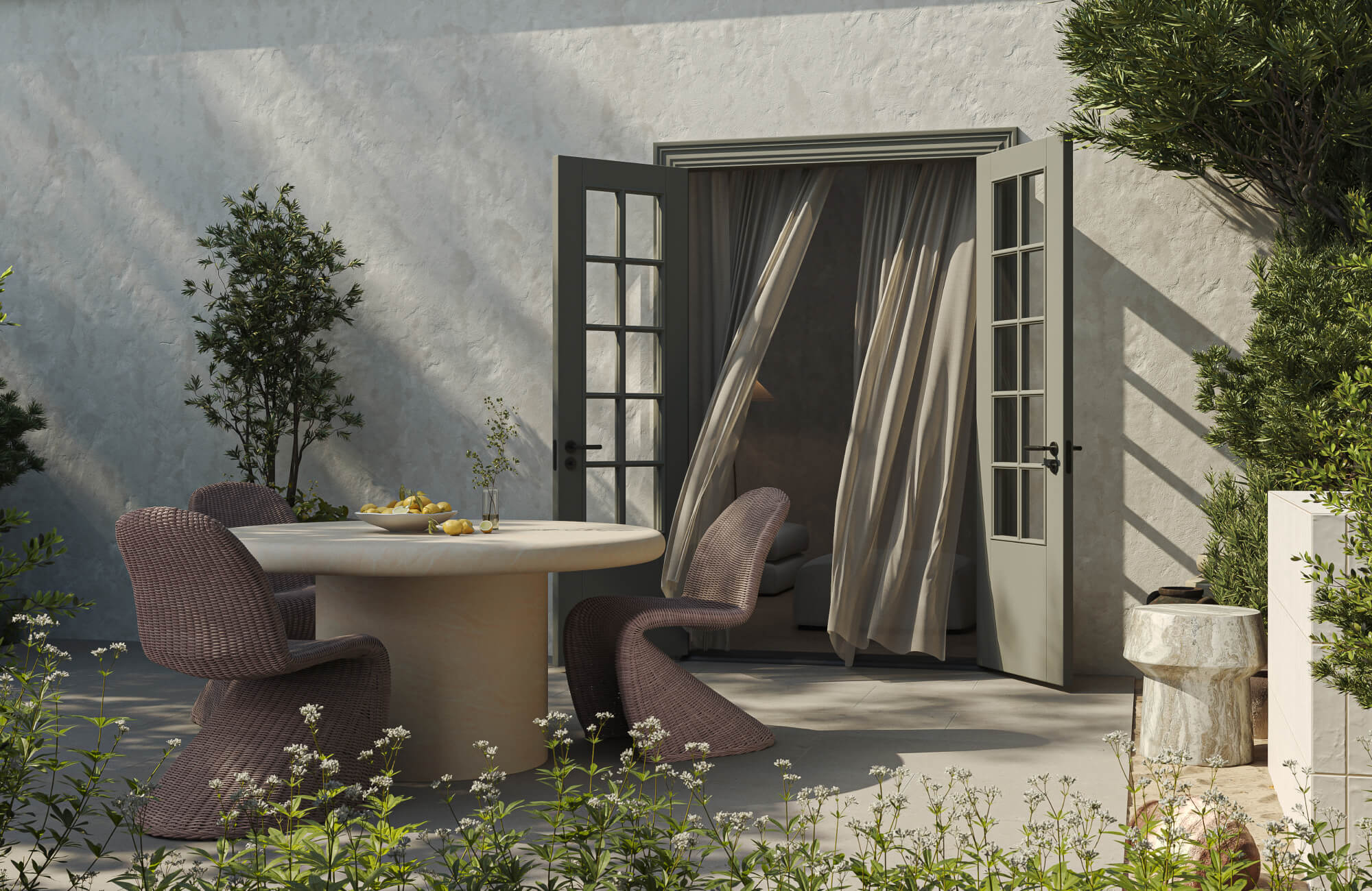 null Sunlit courtyard with a round stone dining table, woven sculptural chairs, open French doors, and surrounding garden plants.