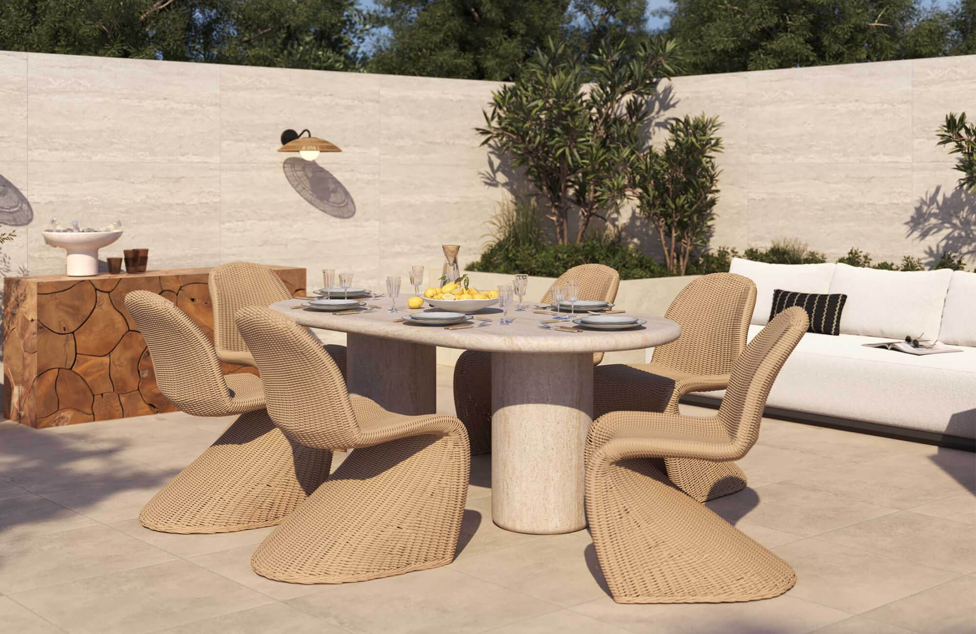 Sunlit outdoor dining space with woven chairs and a solid table on a tiled patio, highlighting materials designed to withstand strong UV exposure and heat