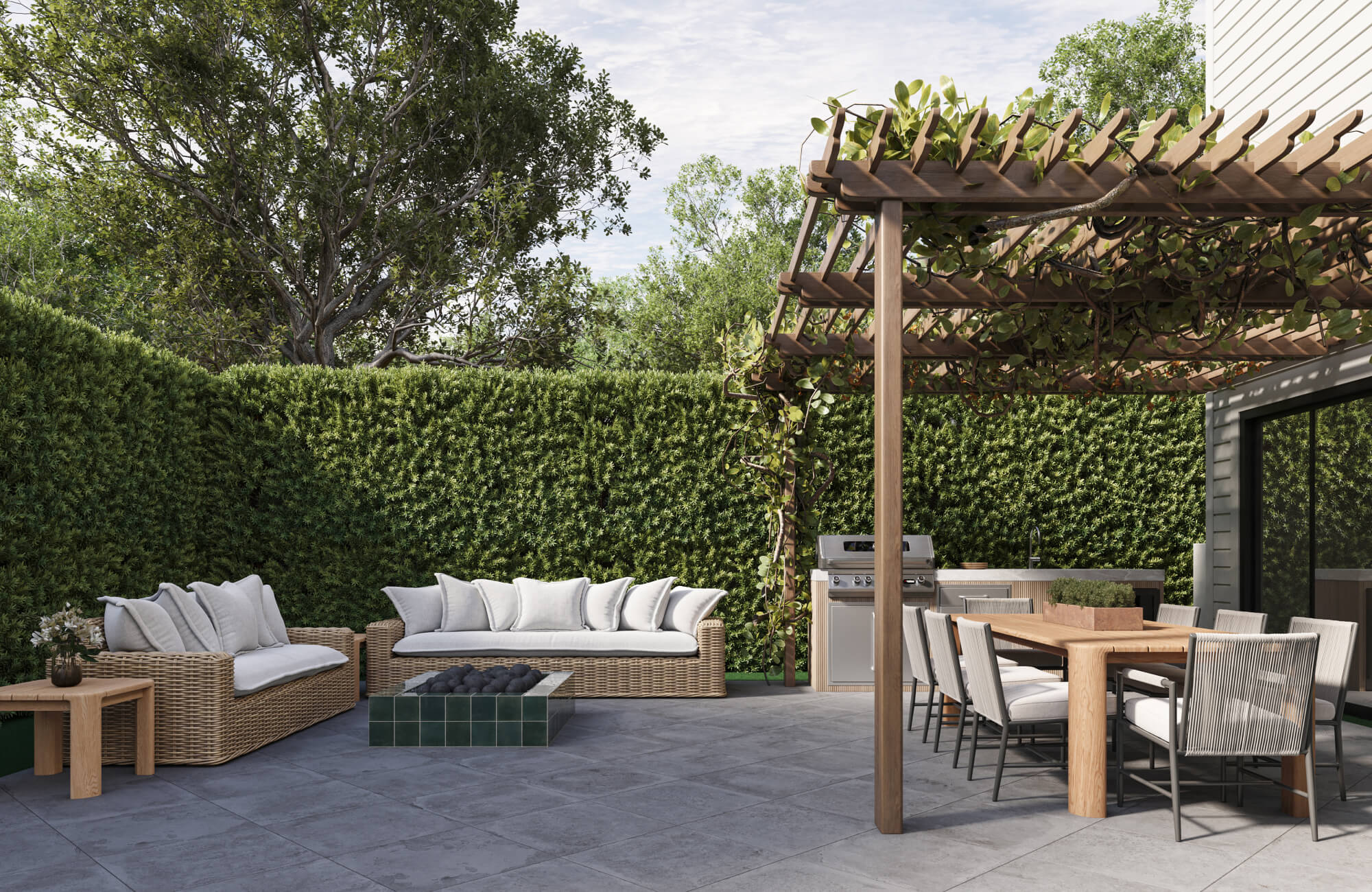 Backyard lounge and dining setup with wicker seating and a wood table under a pergola, showing how different materials handle partial shade and open-air exposure